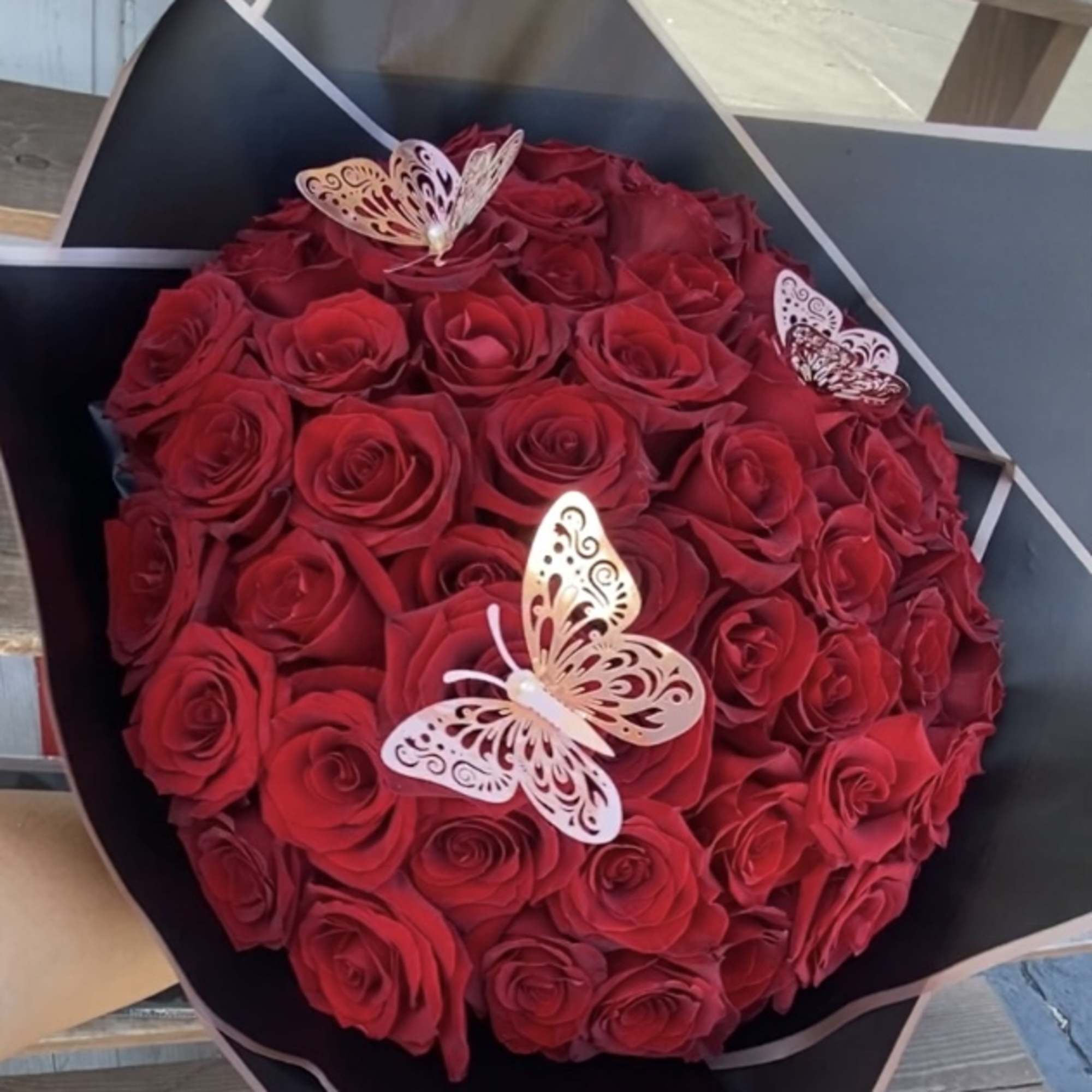 50  Ecuadorian Long stem Red Roses wrap in black Korean paper.