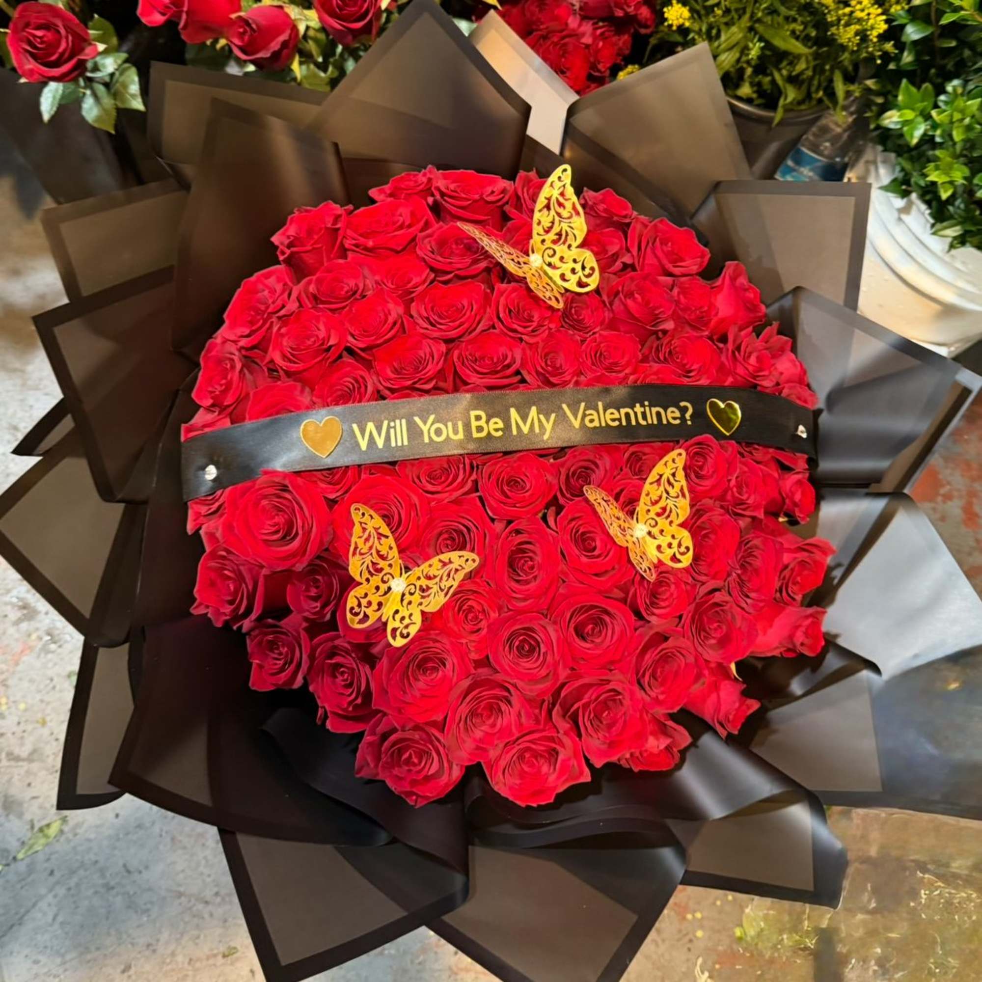 50  Ecuadorian Long stem Red Roses wrap in black Korean paper.