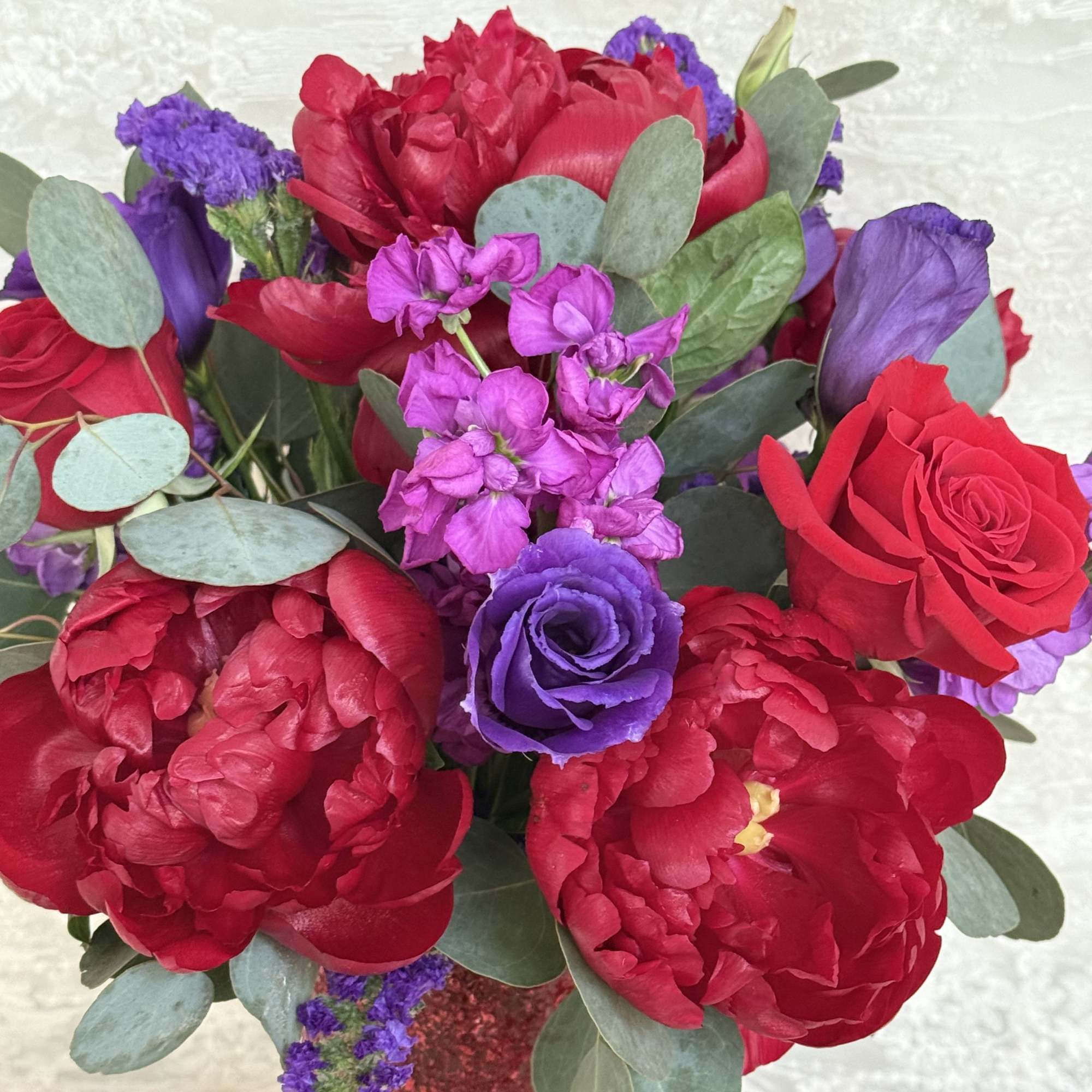 Peonies, roses, lisianthus, stock, statice and eucalyptus 