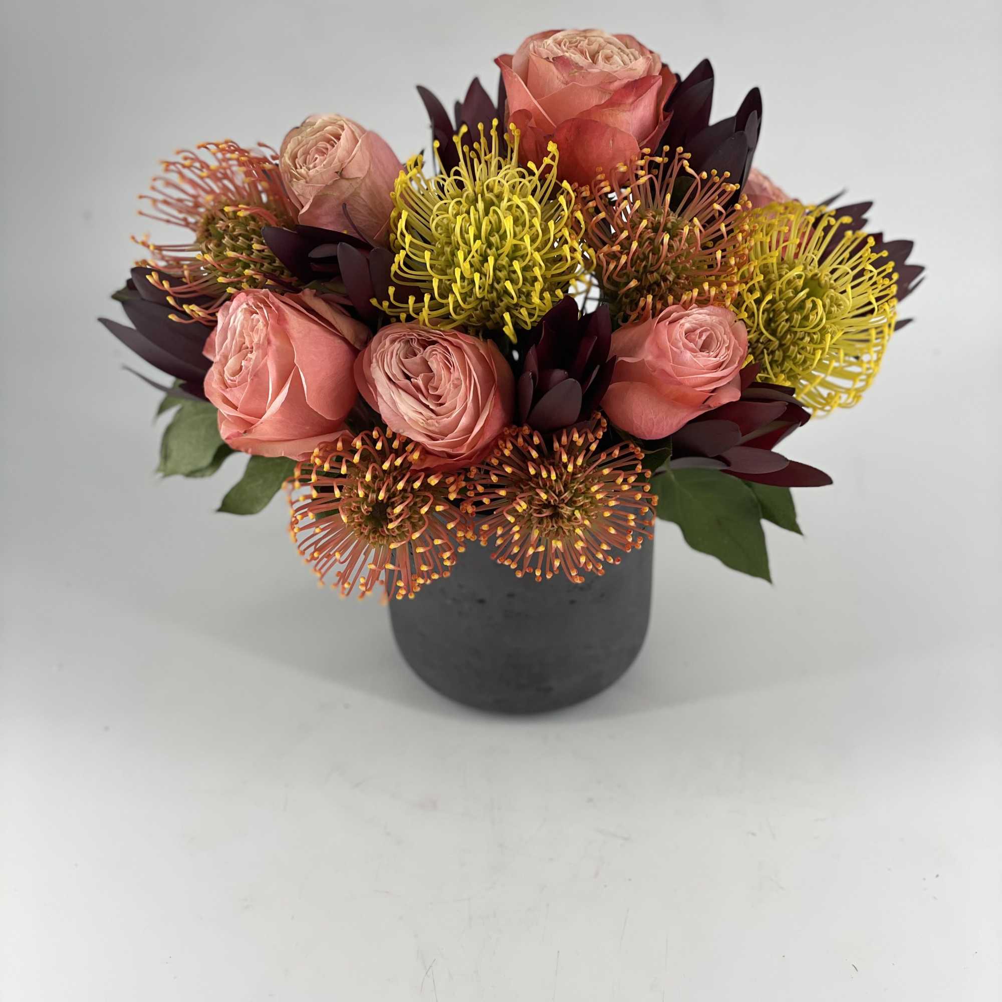 The focal points of this unique arrangement are the varieties of Protea.