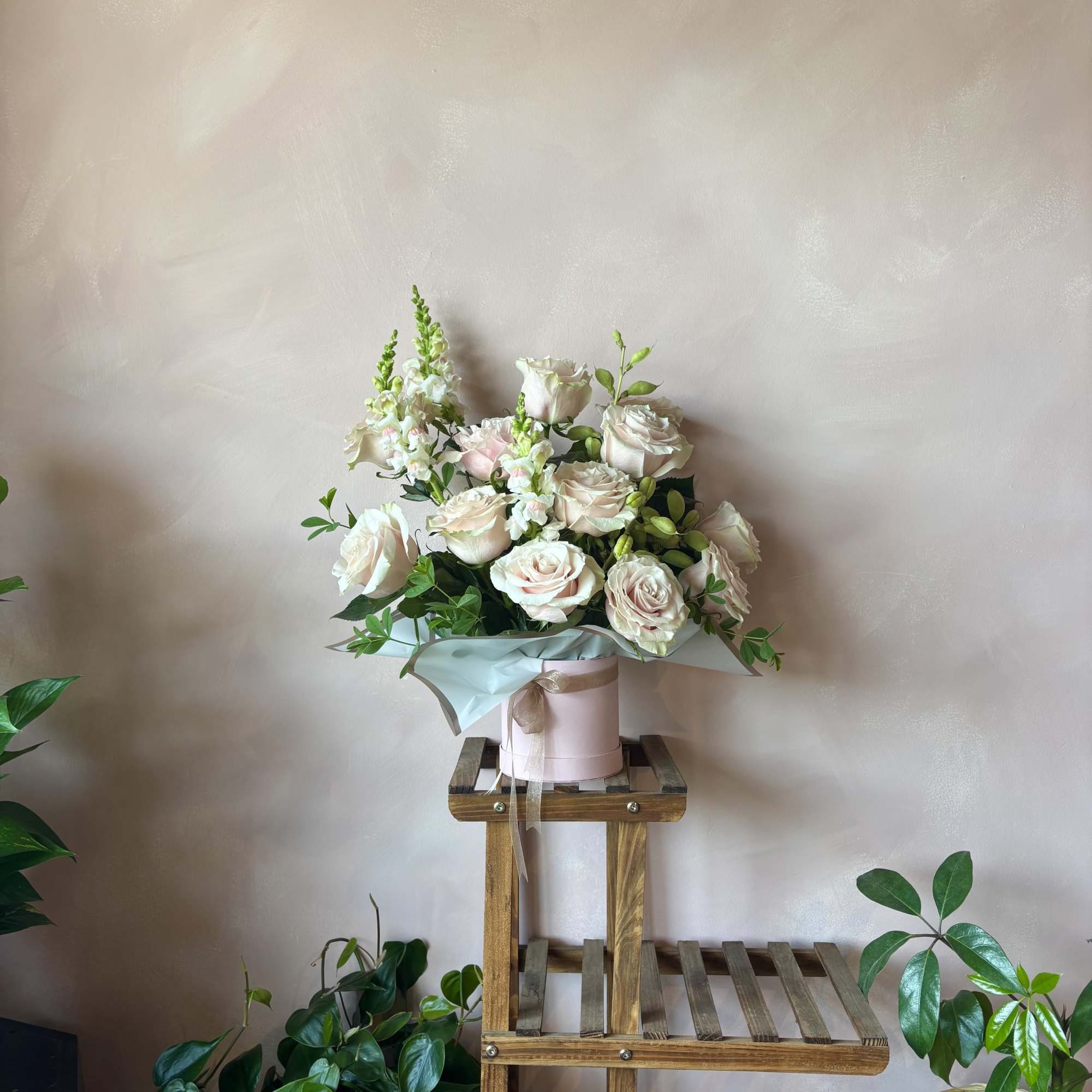 One dozen stunning roses paired with creamy complimentary blooms and lush greenery