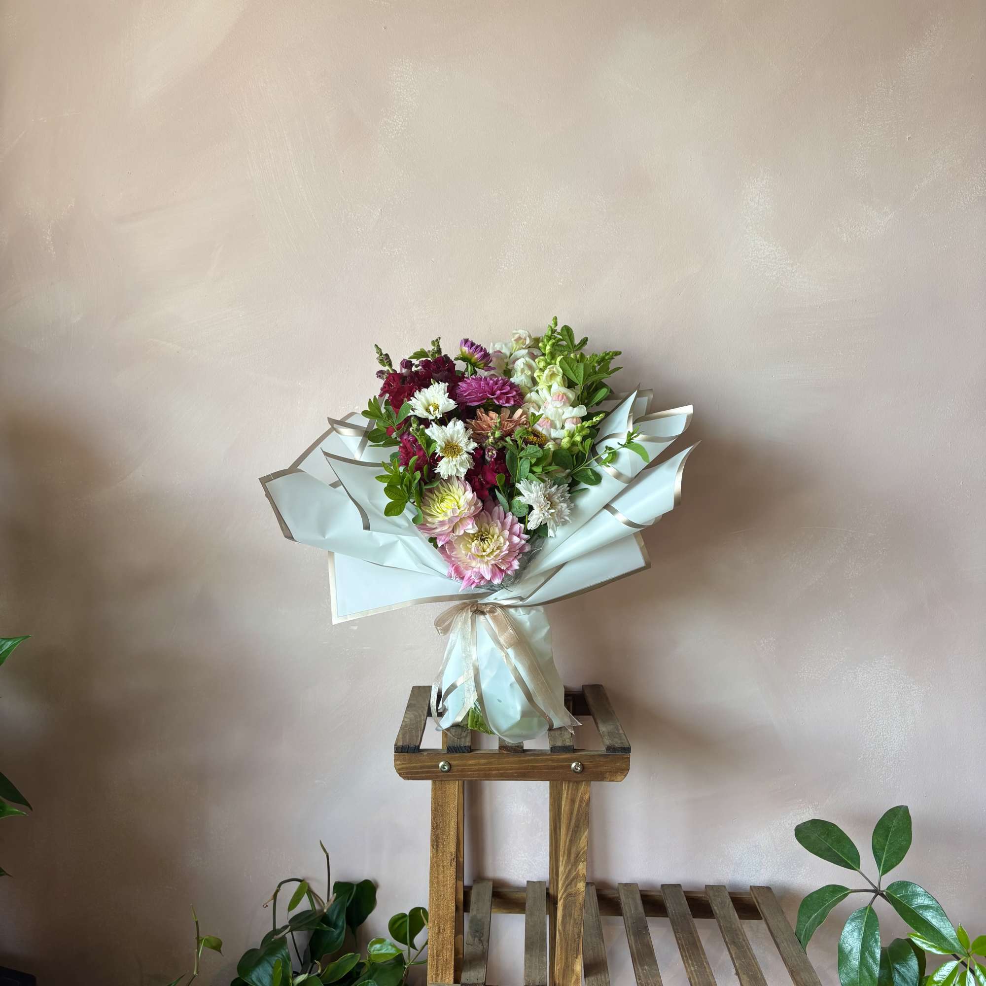 Vibrant mix of fresh assorted blooms in our premium wrapping and finished