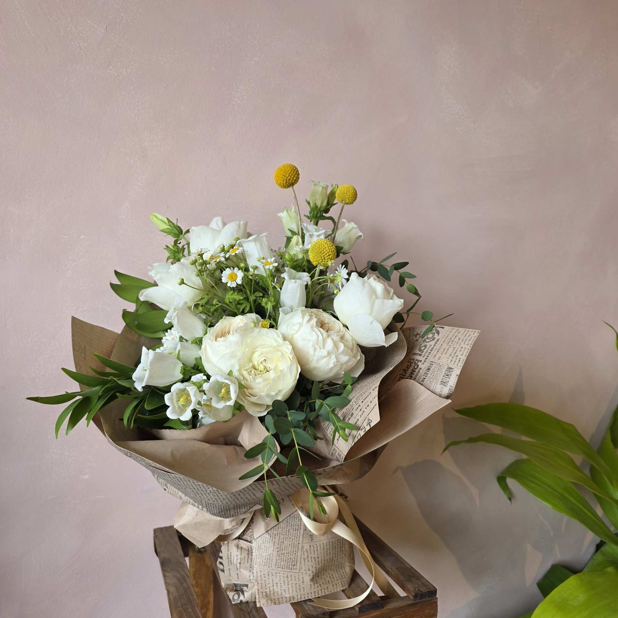 A white mixed garden bouquet with the subtlest pops of yellow create