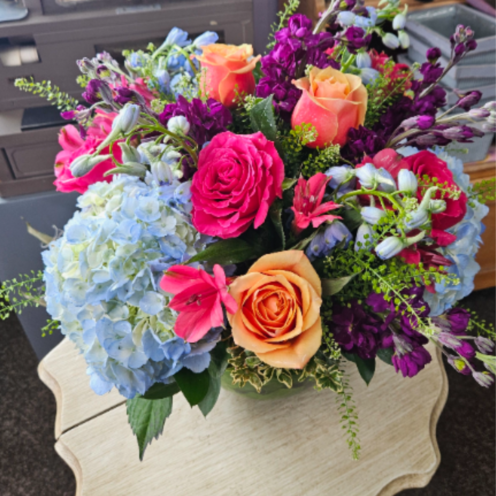 Stunning mix of pale blue hydrangeas, sky blue delphinium, hot pink and