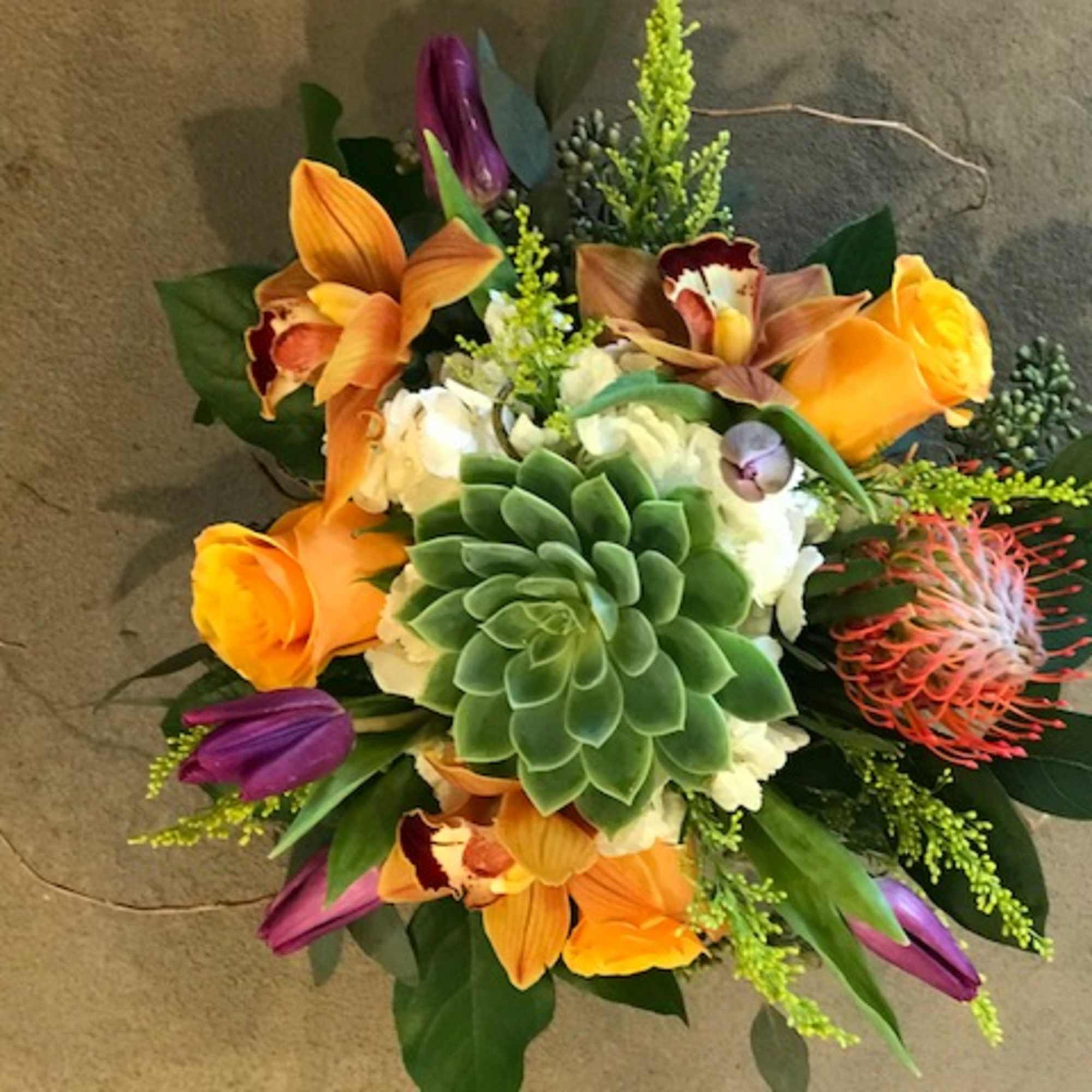 hydrangea, succulent, pin cushion protea, cymbidium orchid, tulips, roses, saladago, eucalyptus, curly