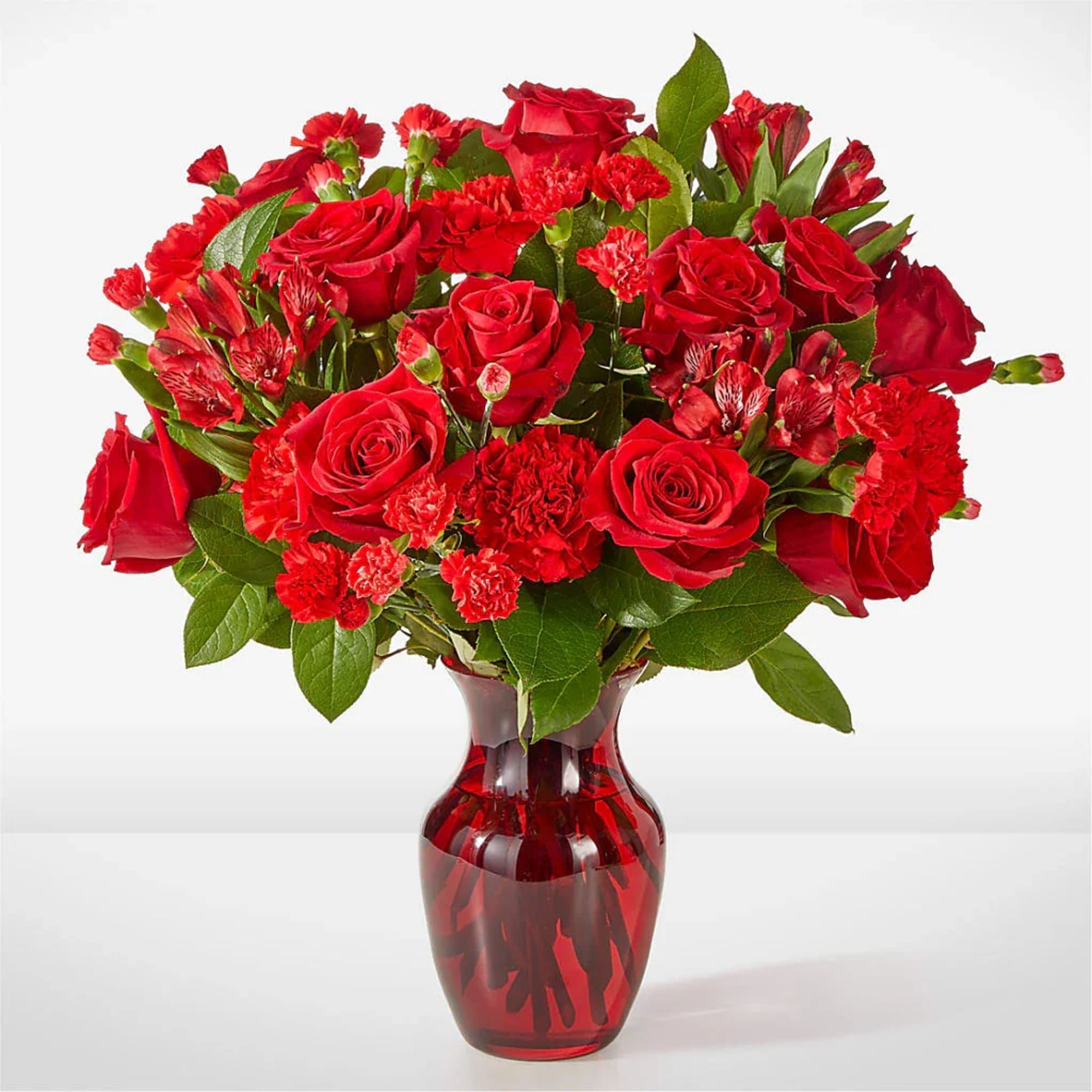 A valentine in bloom, this all red arrangement of roses, carnations and