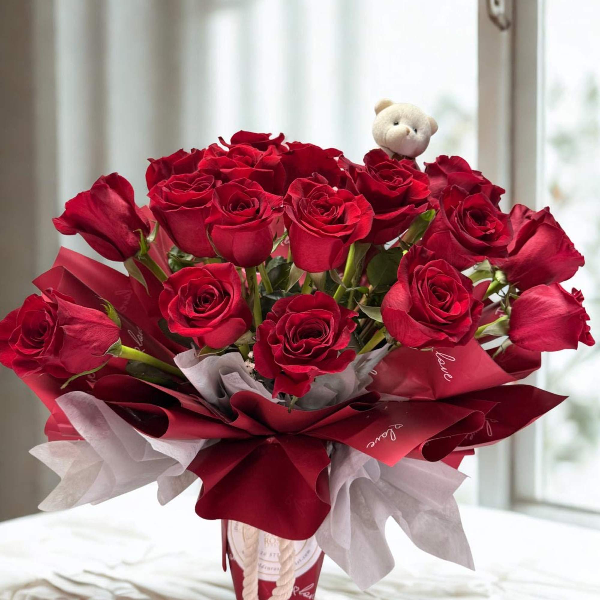 An elegant bouquet of premium red roses, beautifully wrapped, perfect for expressing