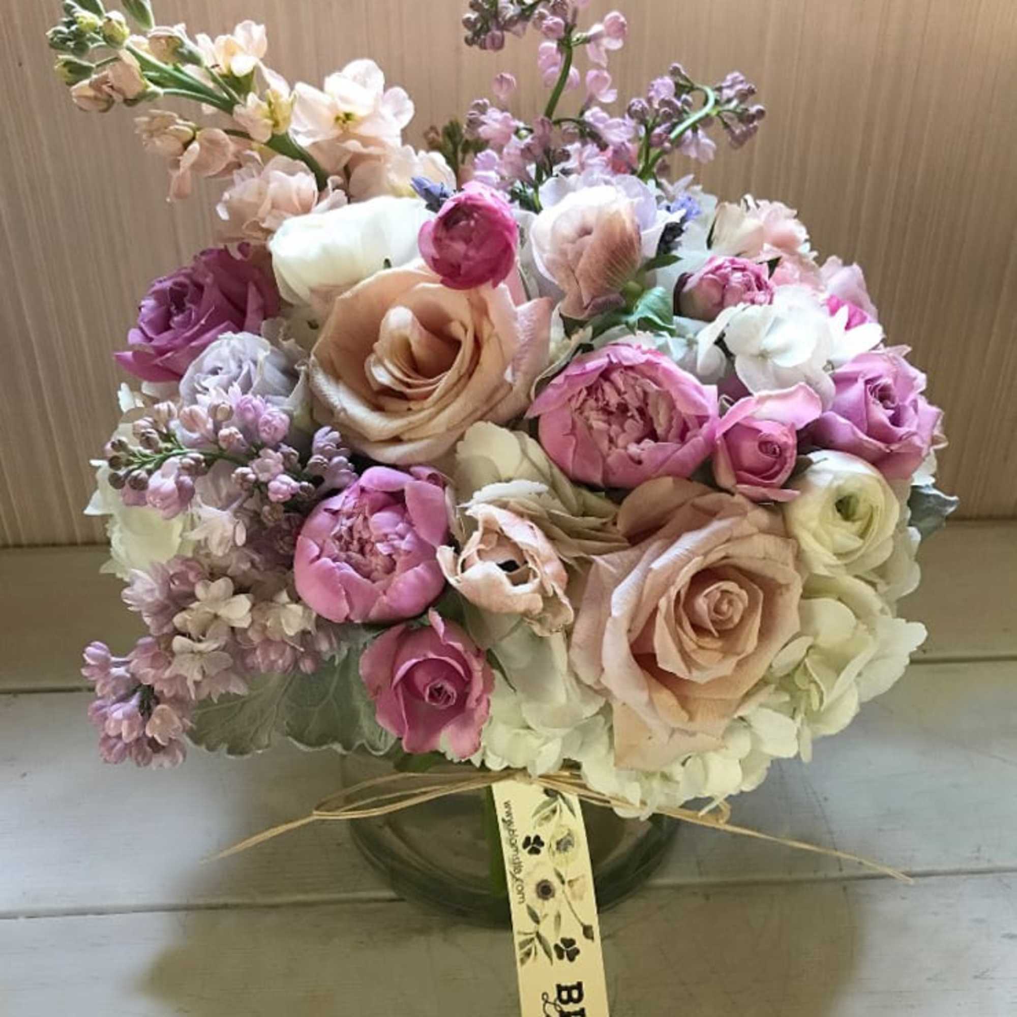 A violet, pale pink pastel arrangement with the finest colors and flowers.