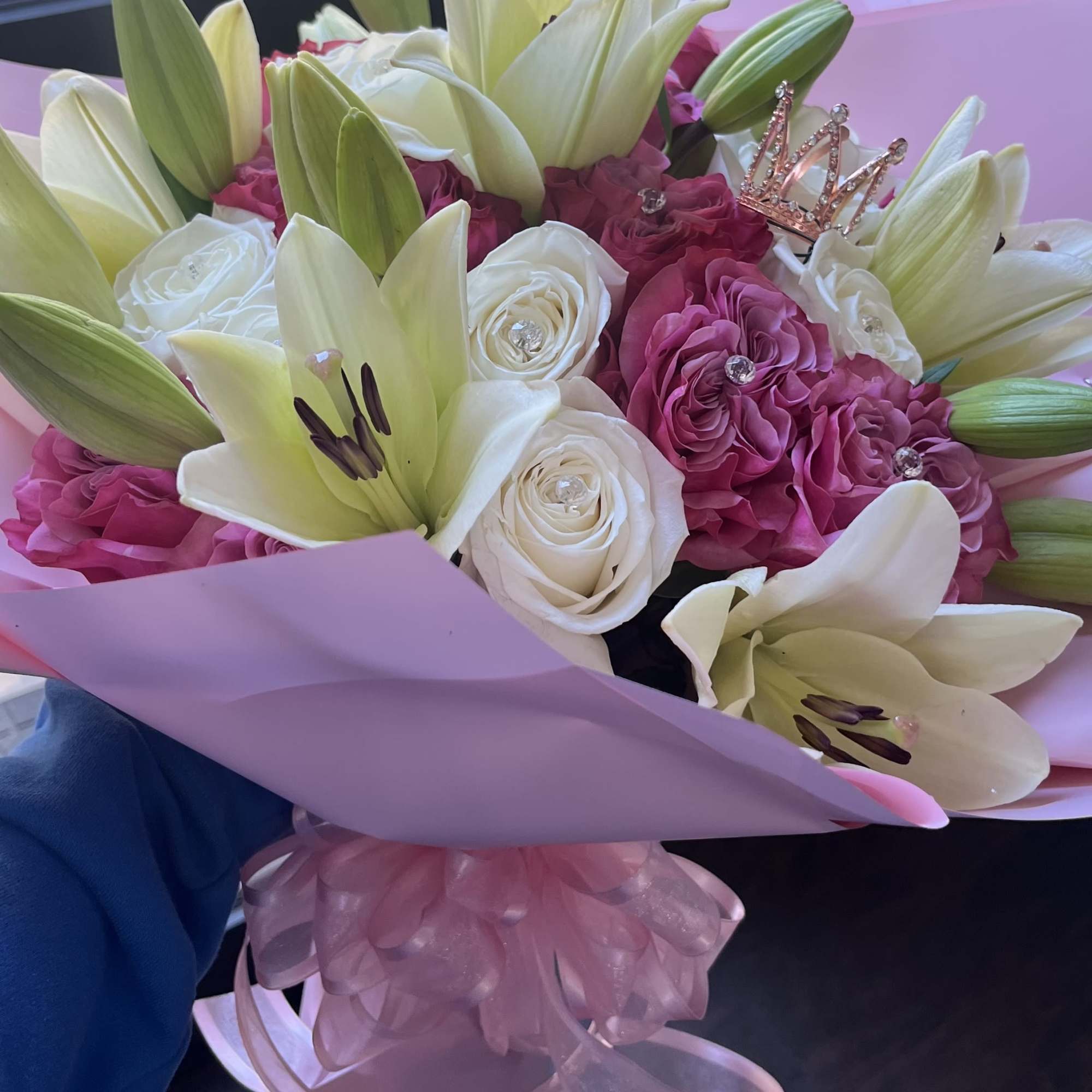 Two dozen roses with lilies wrapped with a large bow, Crown and