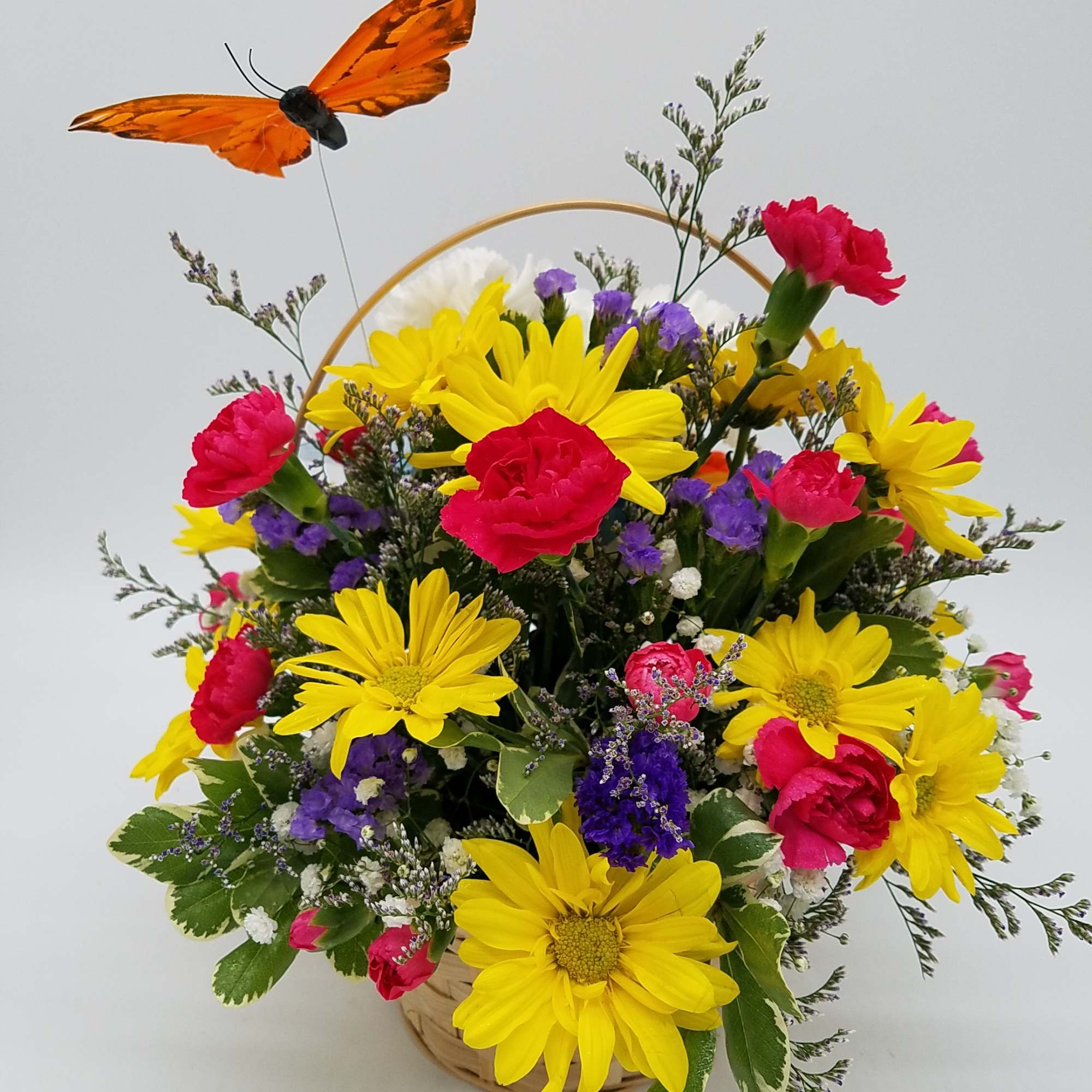 Designed out of white carnations, this puppy is sure to put 