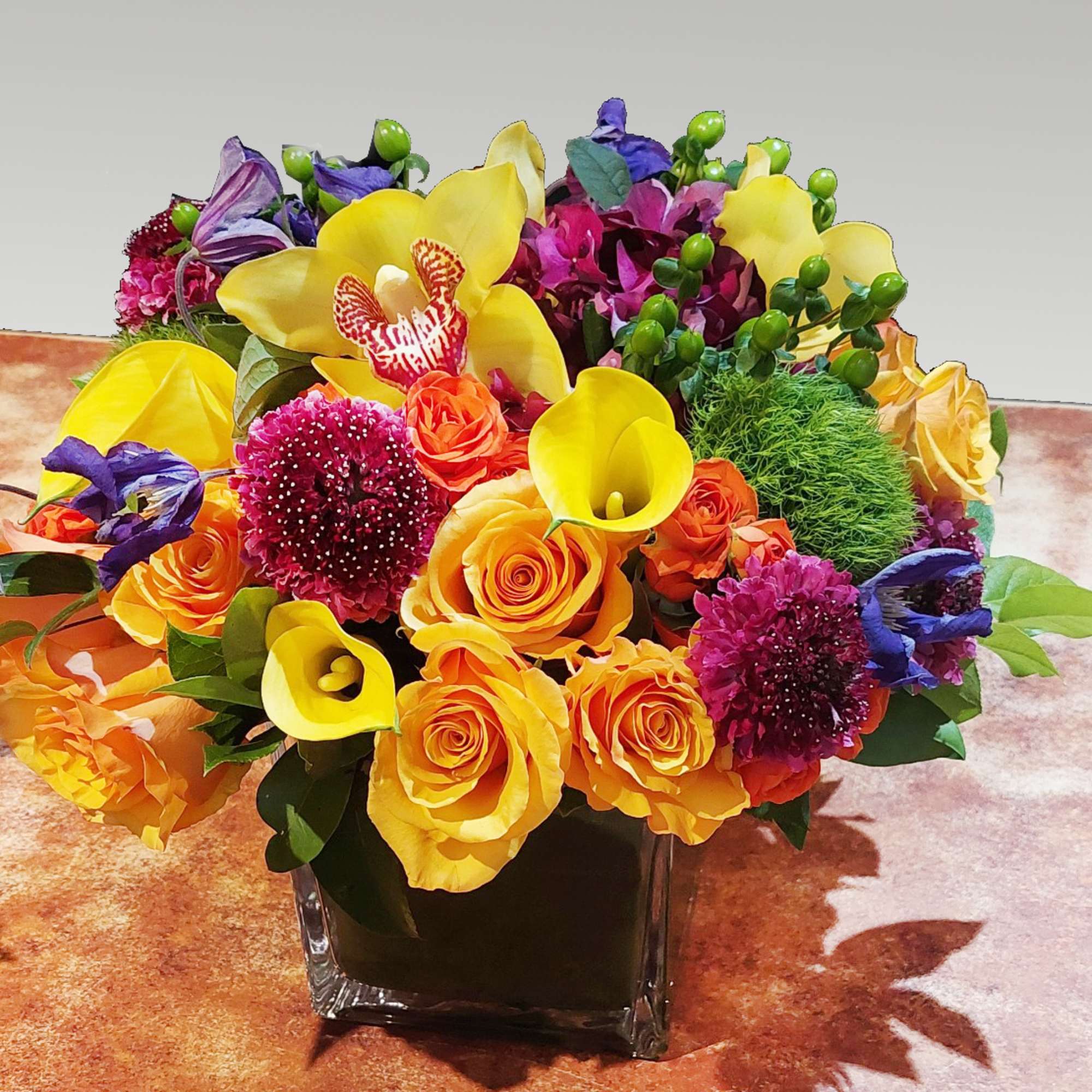 This classic colorful arrangement is presented in a 6" cube vase. It