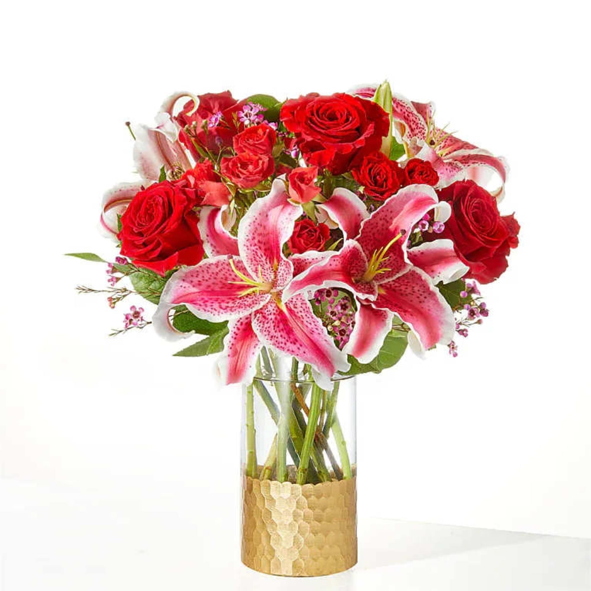 Blooming red roses, exquisite lilies, and accents of spray roses are expertly