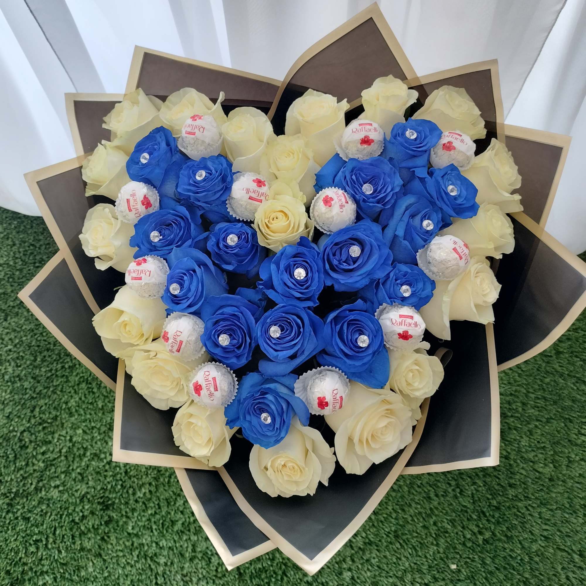 36 blue and white roses, wrapped in black paper, Ferrero Rocher and
