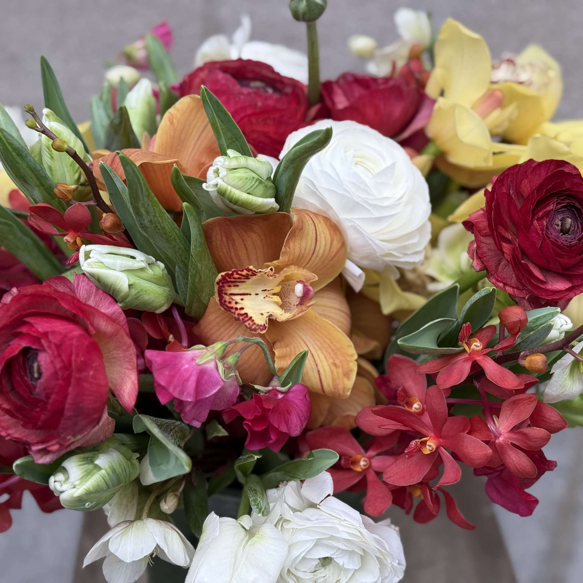 A low and plump arrangement that&rsquo;s bursting with stunning white and hot