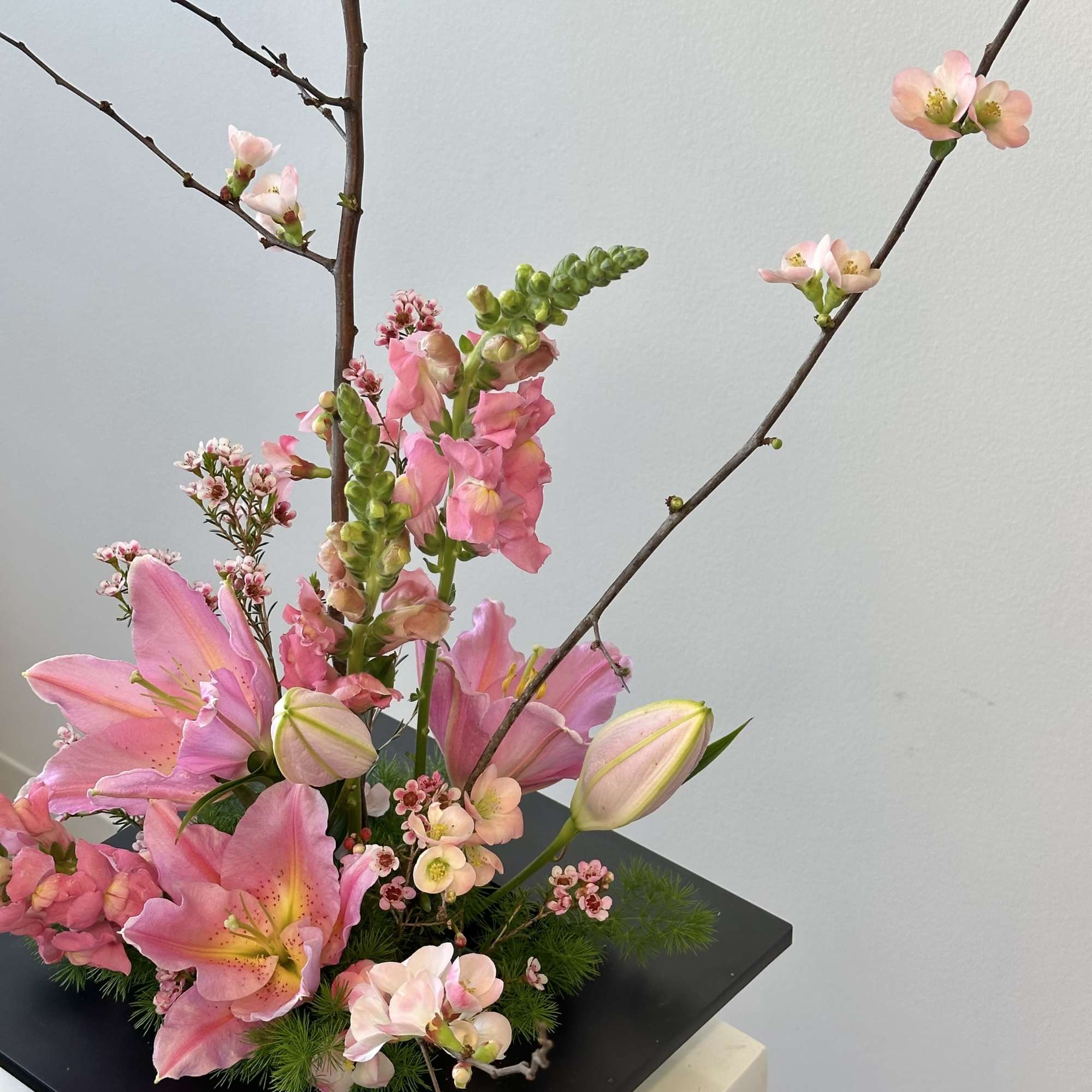 Snapdragons and lilies and blooming branches 