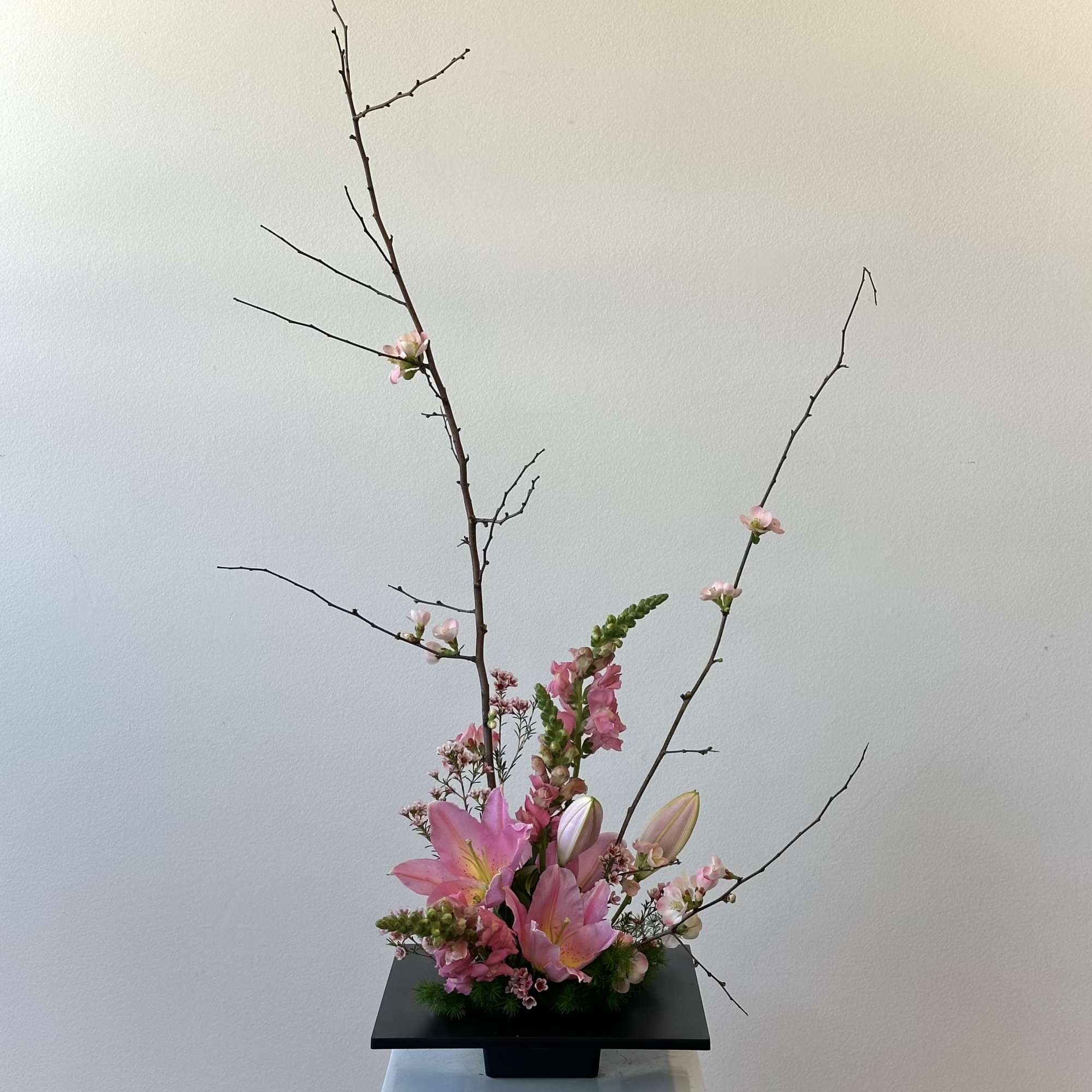 Snapdragons and lilies and blooming branches 