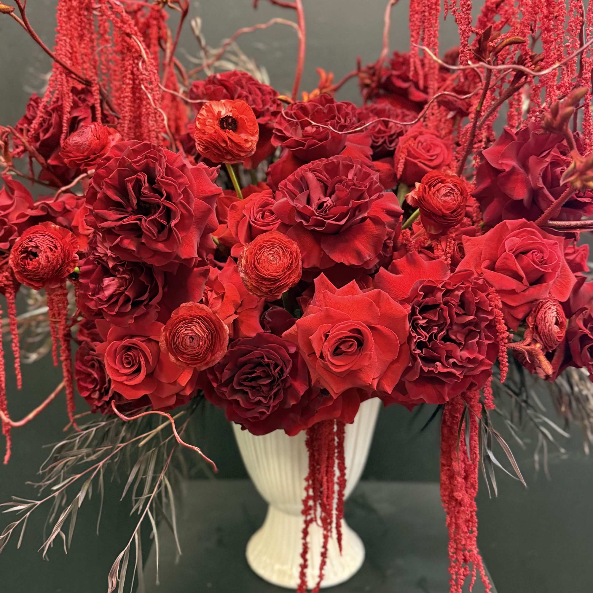 A beautiful mix of rich red flowers arranged with timeless elegance, Scarlet