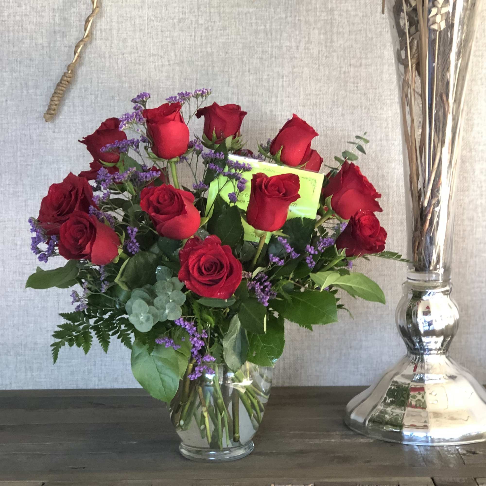 A charming bouquet of a dozen long stem red roses to bring