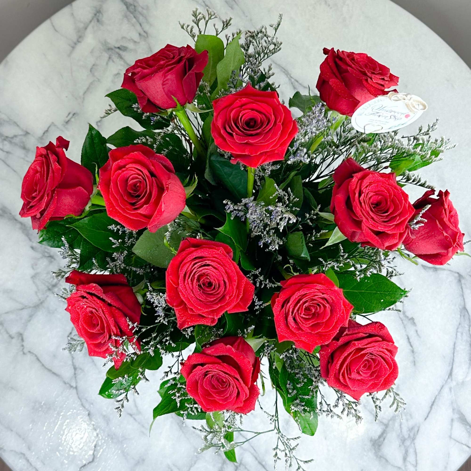 A charming bouquet of a dozen long stem red roses to bring