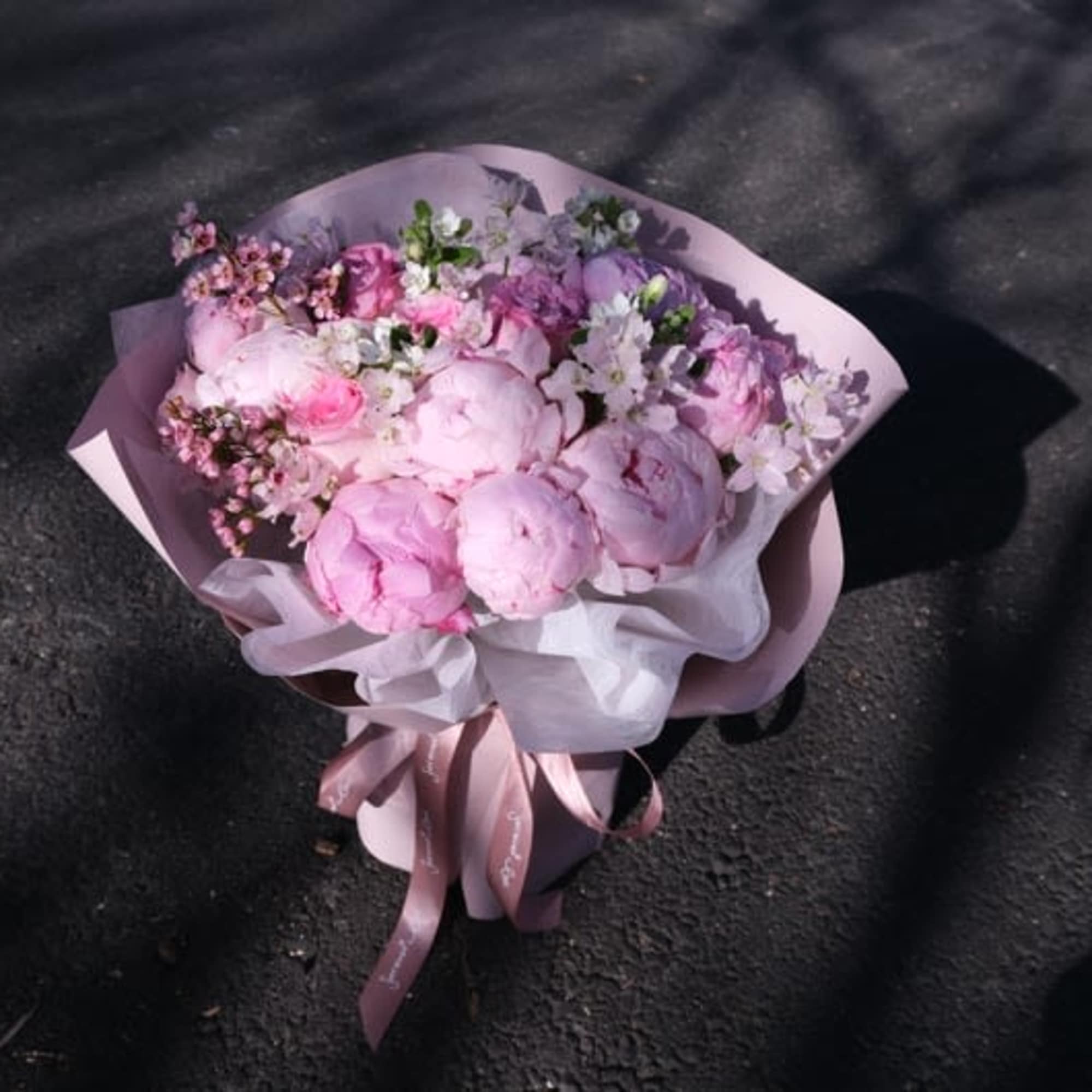 A cloud of blush peonies and garden roses wrapped in soft pink