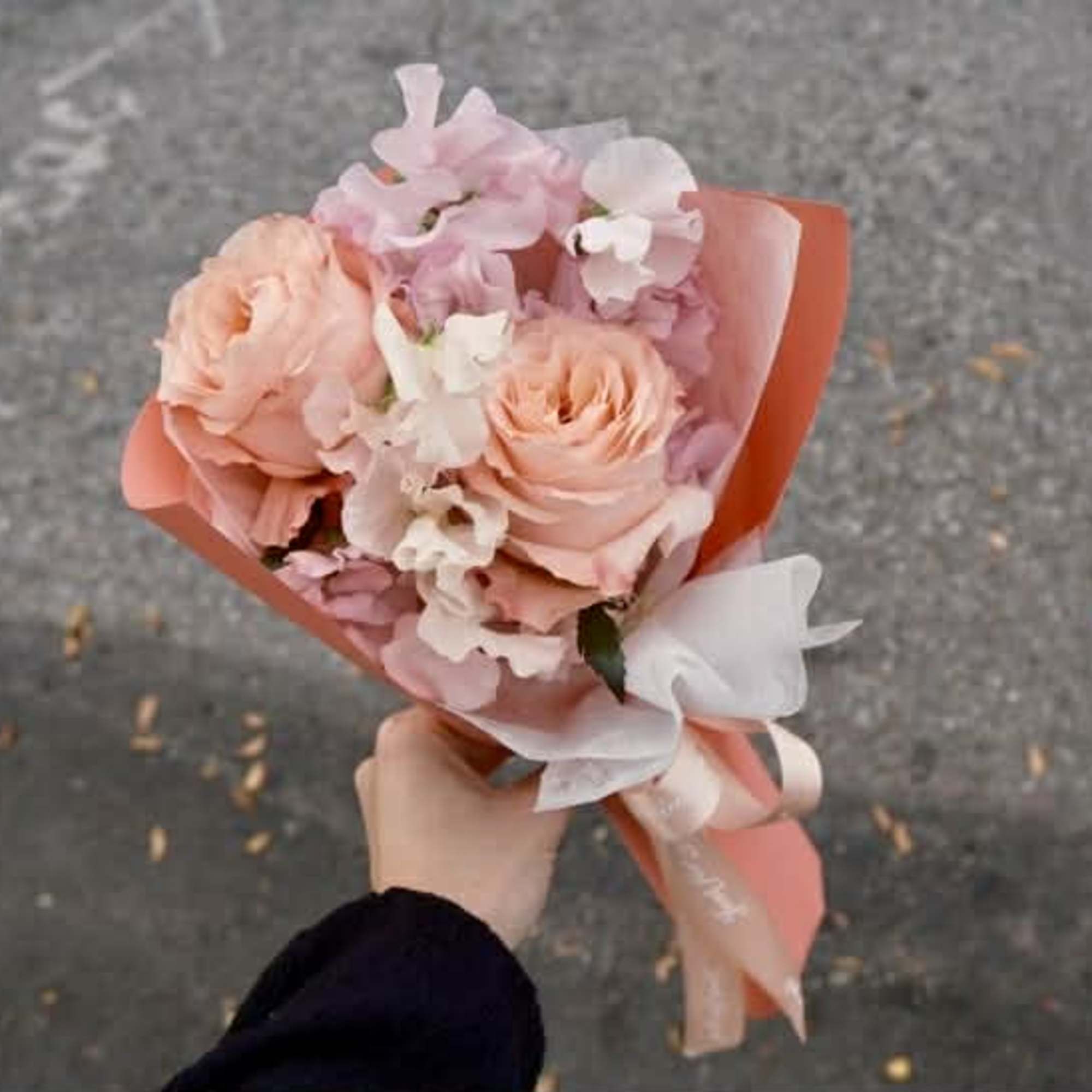 Soft roses paired with airy sweet peas &mdash; a bouquet that feels