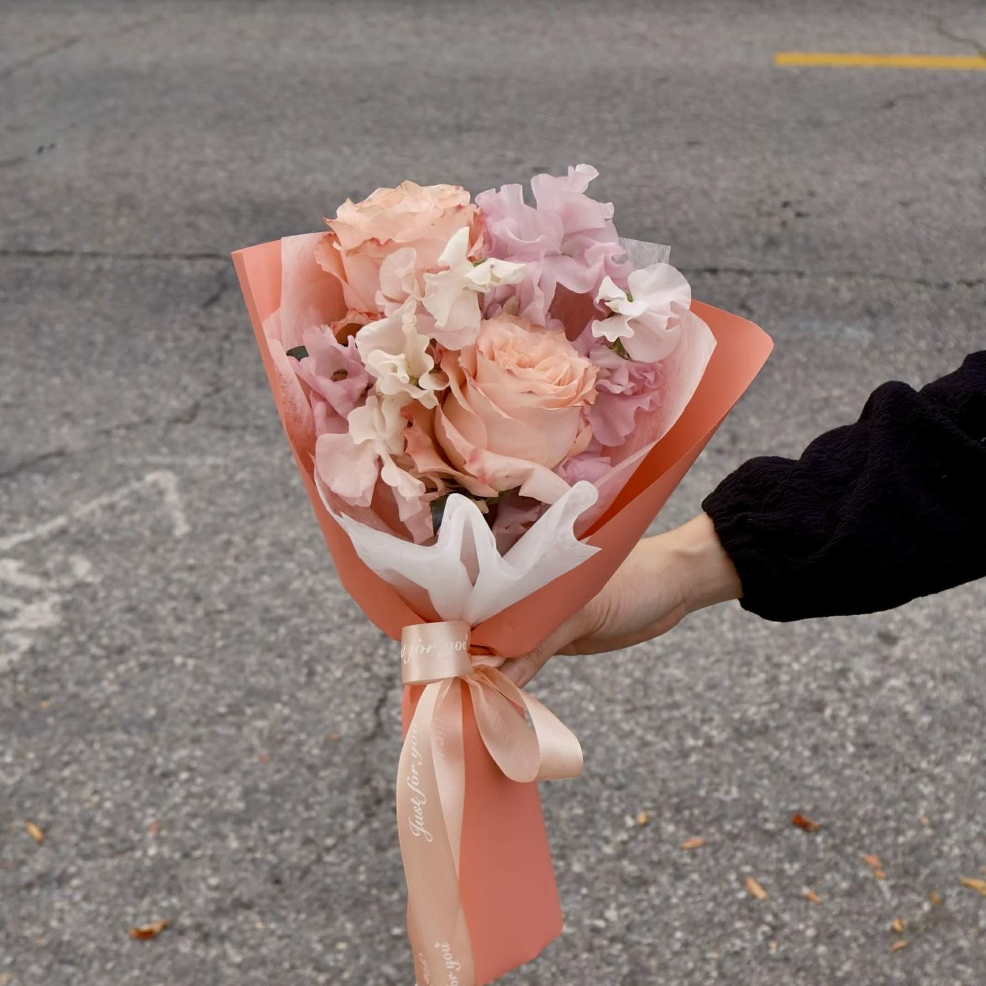 Soft roses paired with airy sweet peas &mdash; a bouquet that feels
