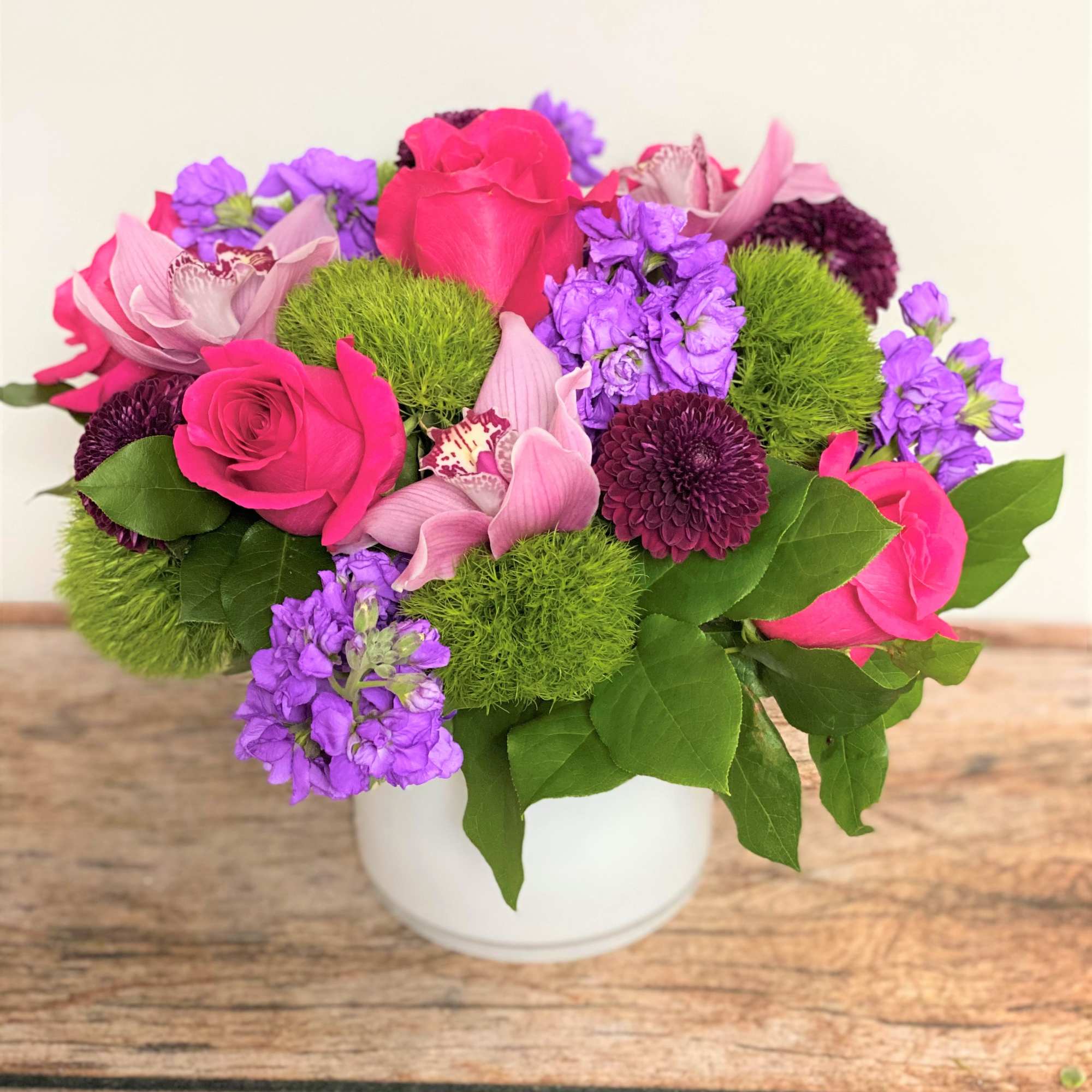 All packaged and ready to go! A full, mixed floral arrangement accompanied