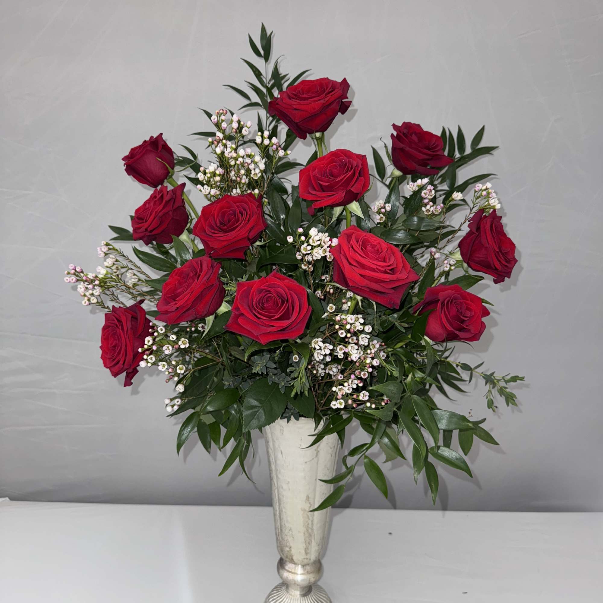 1 DOZEN LONGSTEM ROSES SOPHISTICATELY ARRANGED WITH PREMIUM GREENERY, ITALIAN RUSCUS AND