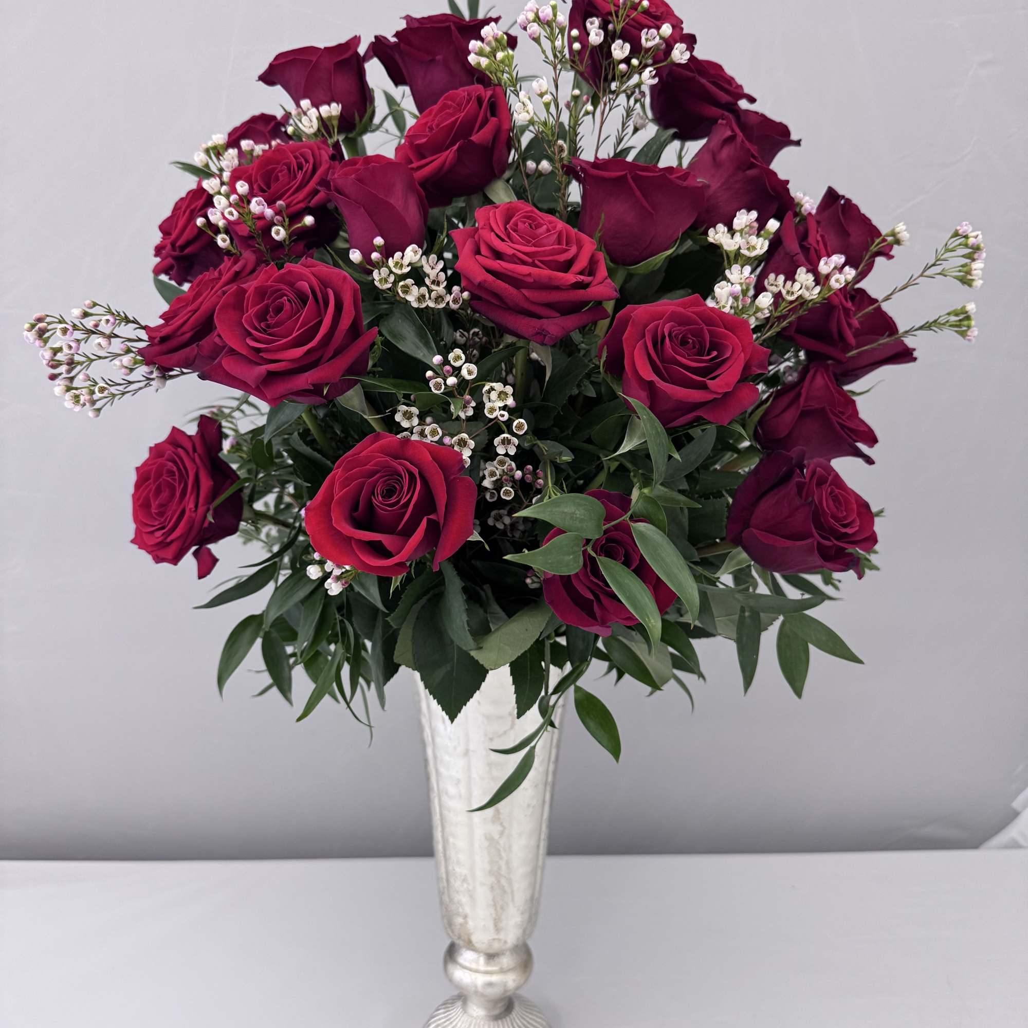 1 DOZEN LONGSTEM ROSES SOPHISTICATELY ARRANGED WITH PREMIUM GREENERY, ITALIAN RUSCUS AND