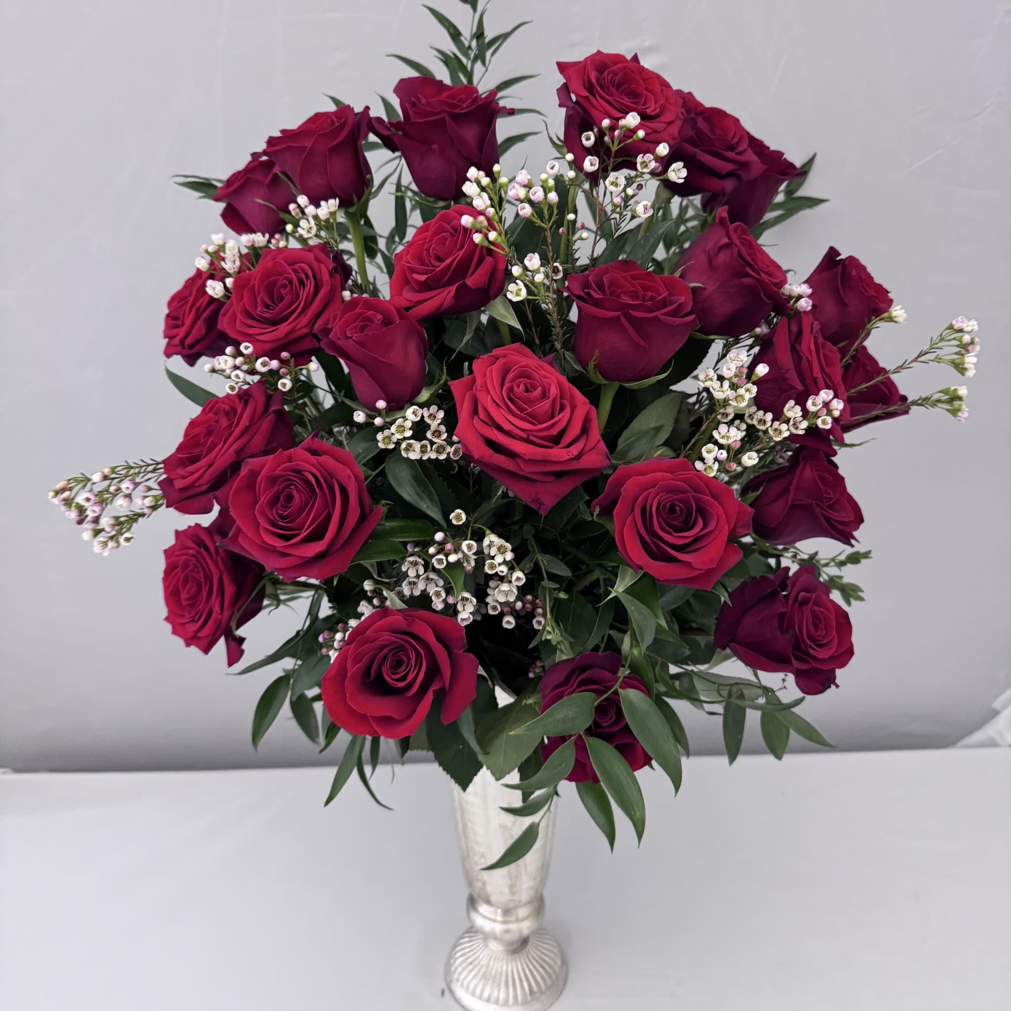 1 DOZEN LONGSTEM ROSES SOPHISTICATELY ARRANGED WITH PREMIUM GREENERY, ITALIAN RUSCUS AND