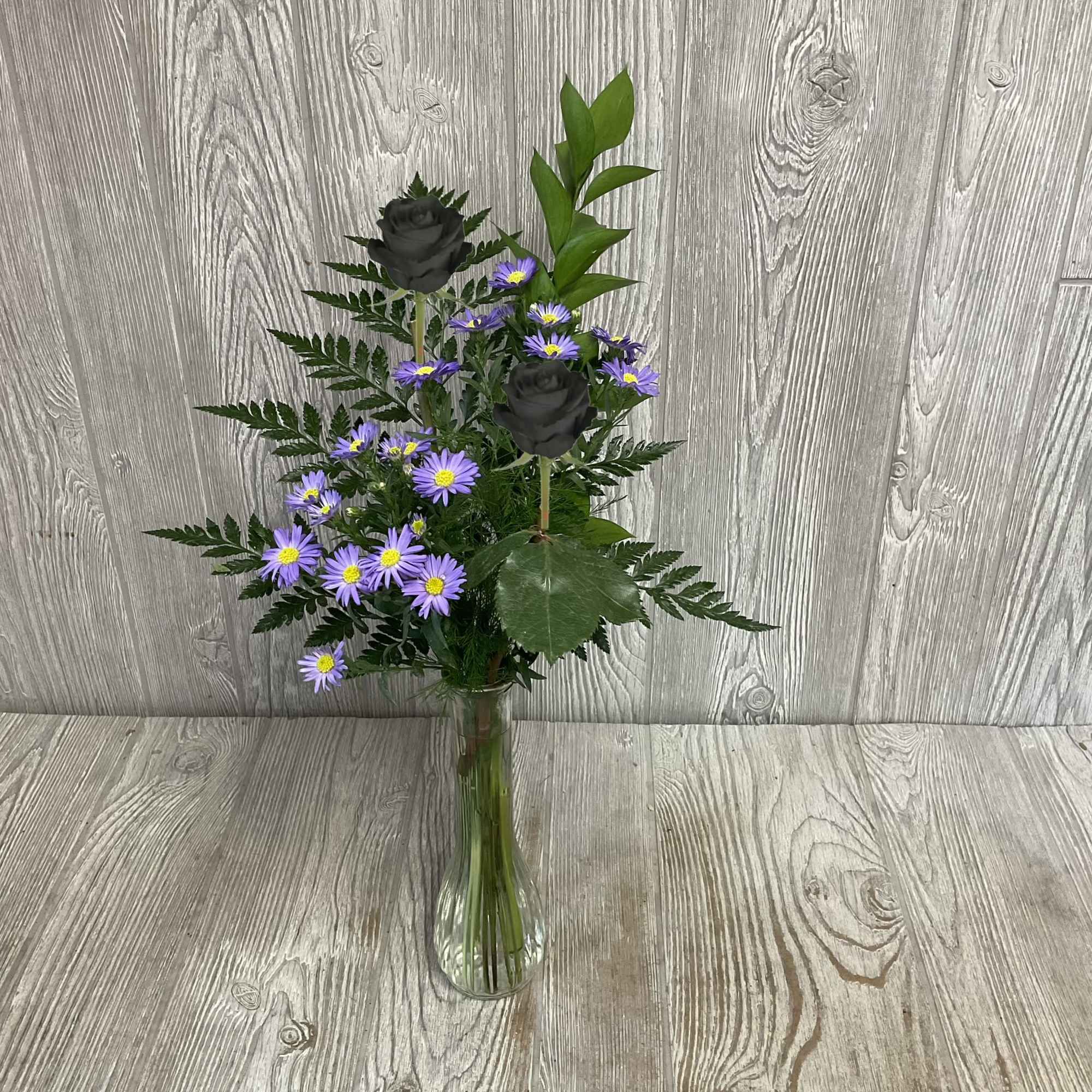 Special available Valentine&rsquo;s week. An enhanced black rose in a bud vase.