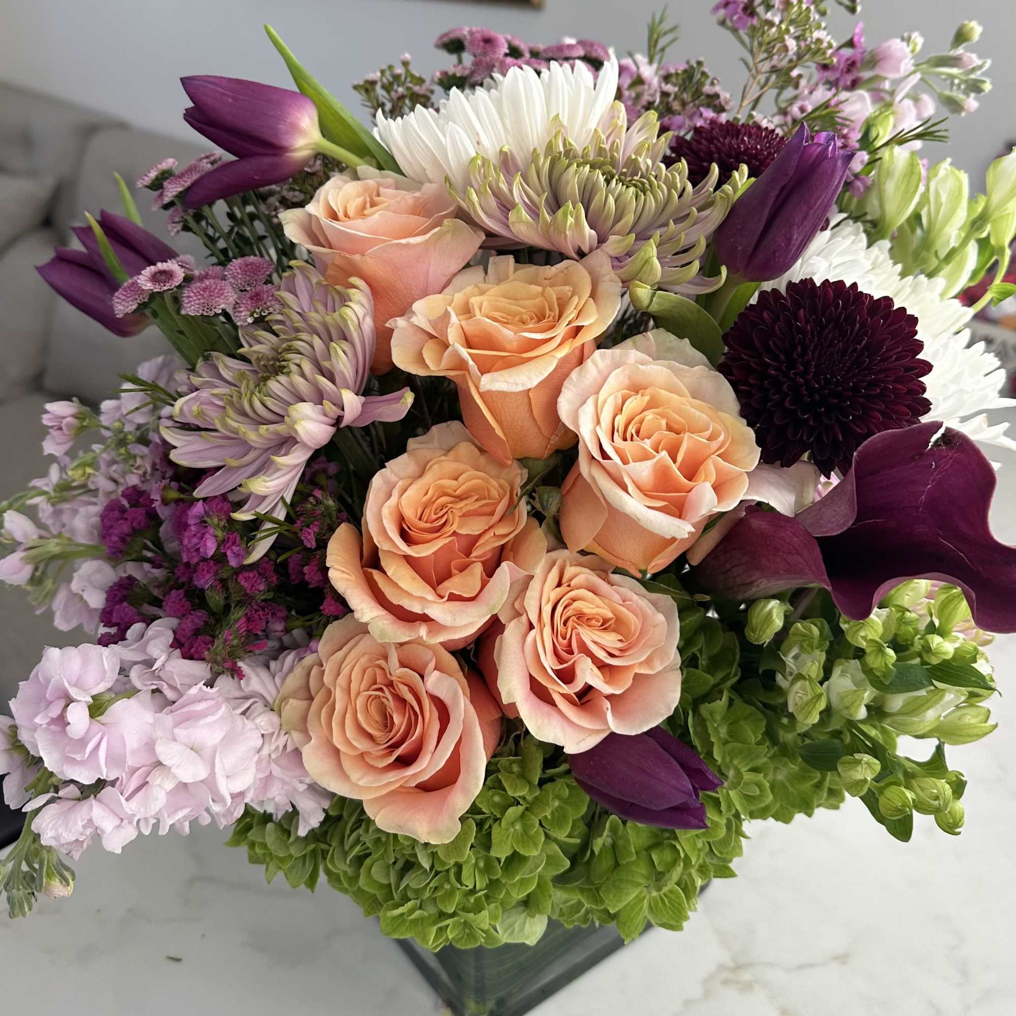 A large statement bouquet filled with a designer's choice of roses, hydrangeas