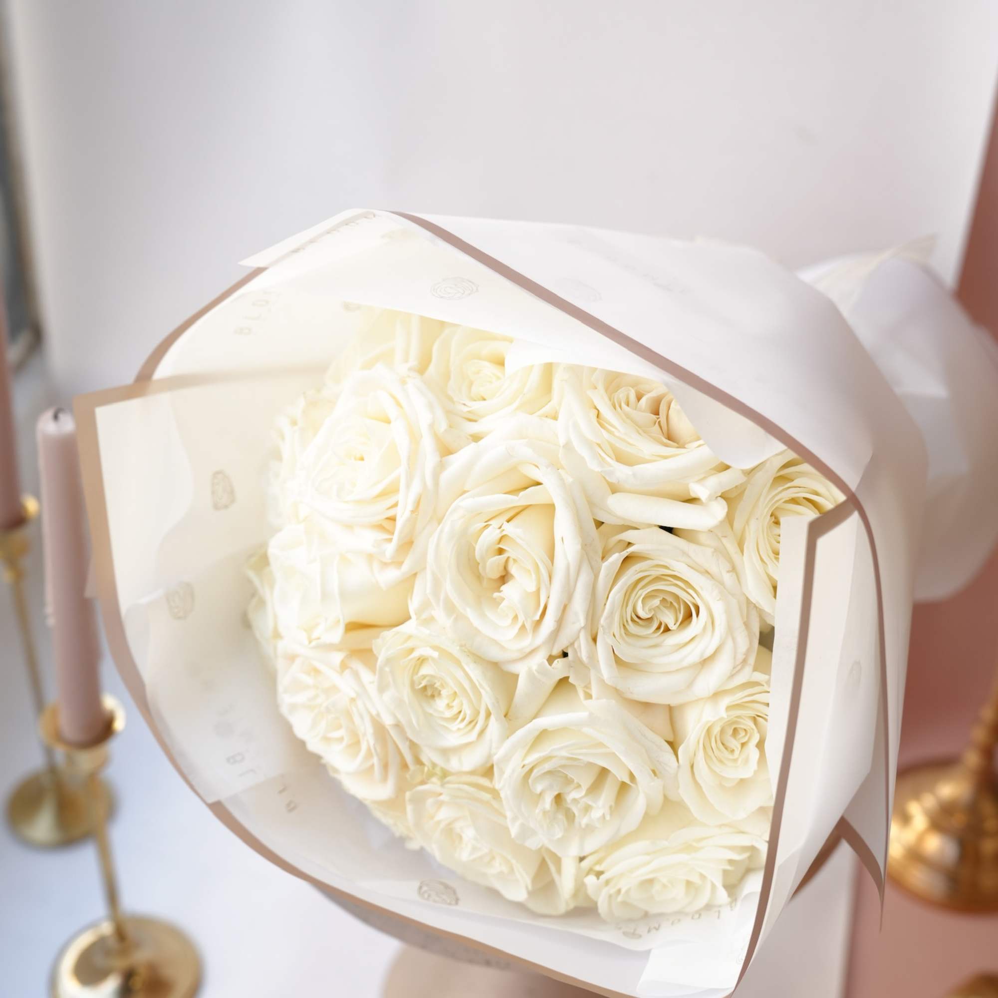 A timeless bouquet white garden roses, beautifully wrapped in paper.