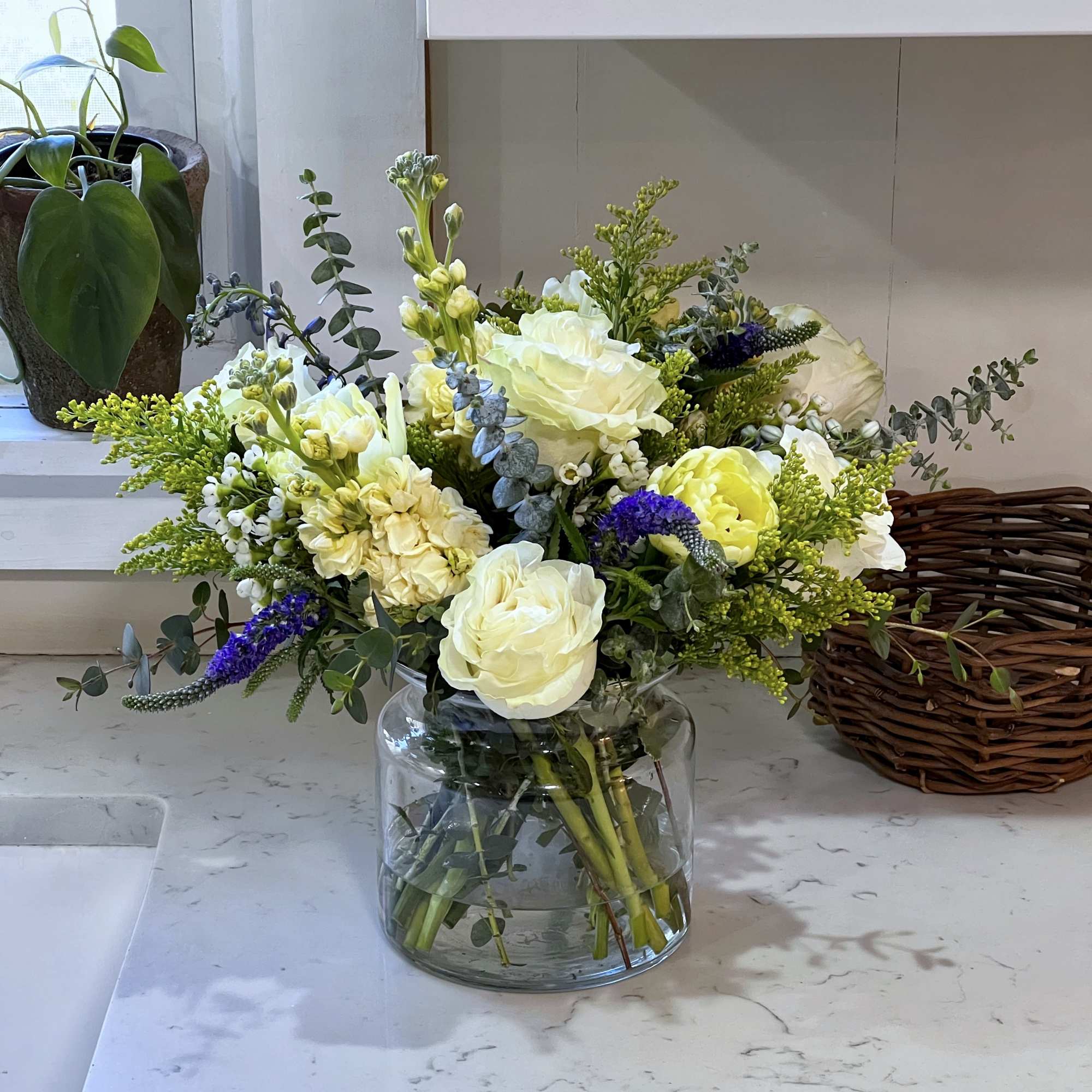 This bouquet is made up of seasonal yellow, white and blue flowers...Roses