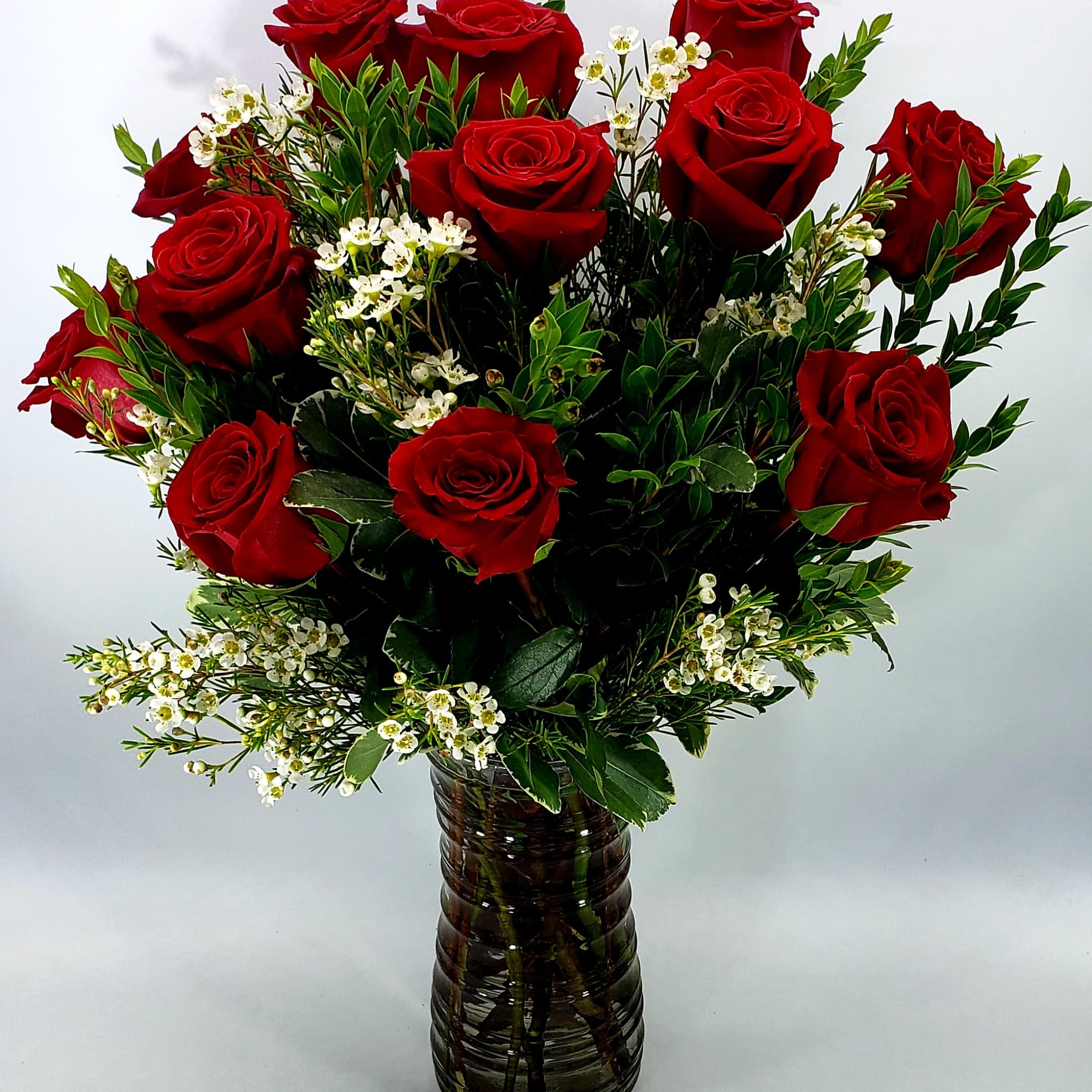 One dozen rich red Rose's warms the heart for all. Choose deluxe