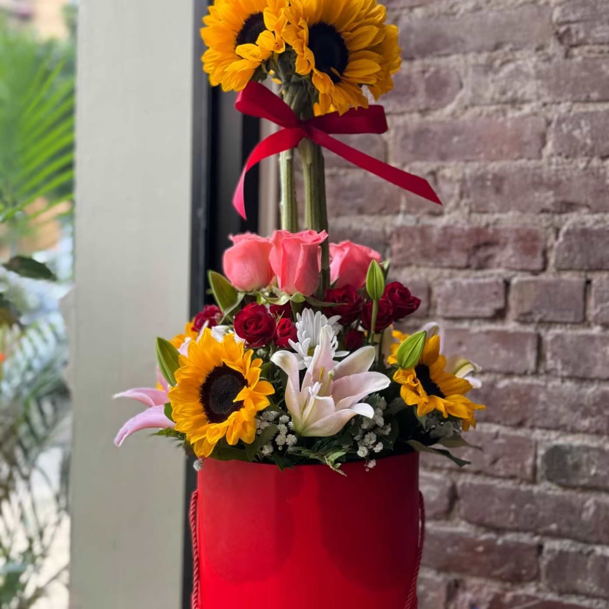 Sunflower arrangement with lilies for any occasion.