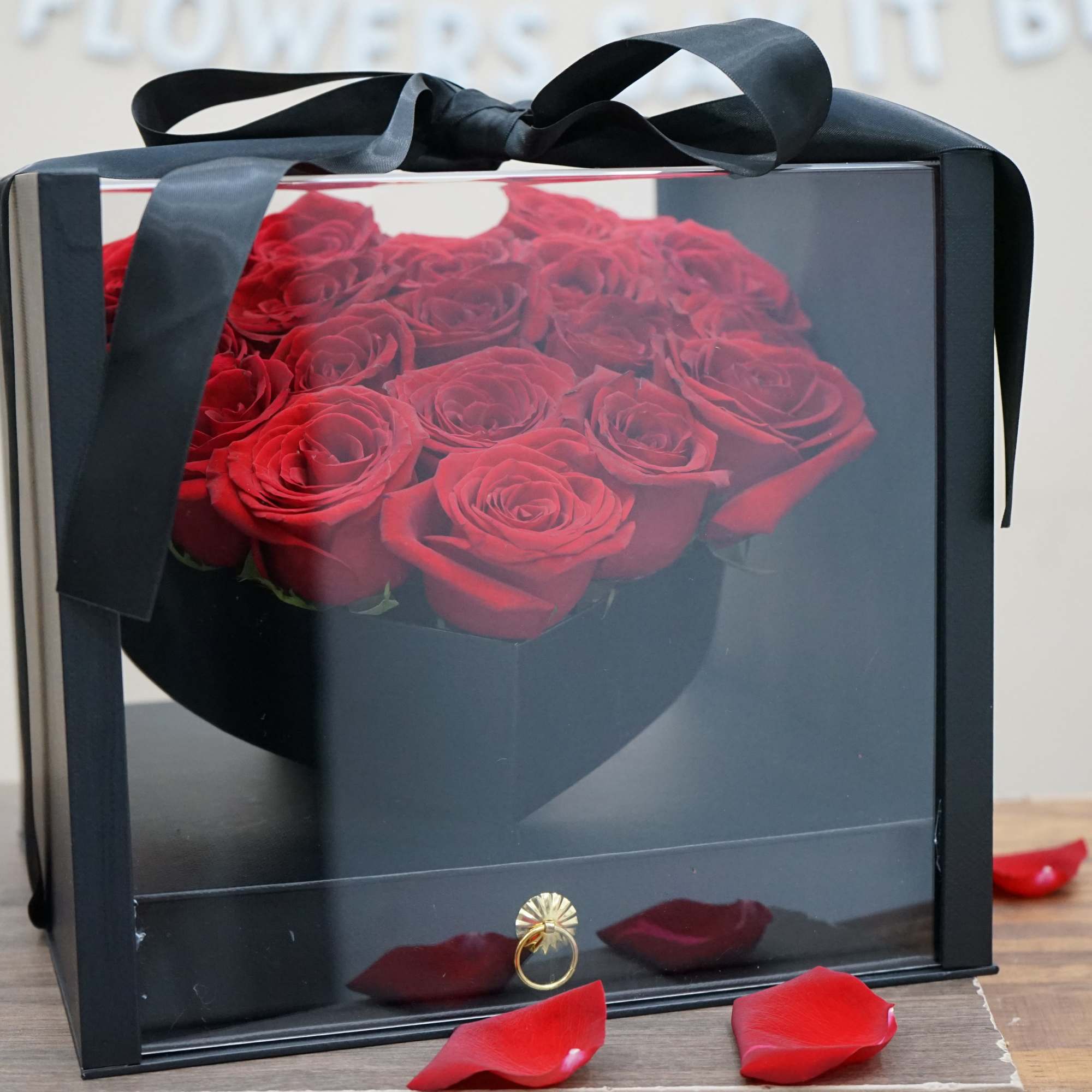 18 red roses and 42 chocolates in a black luxury heart display