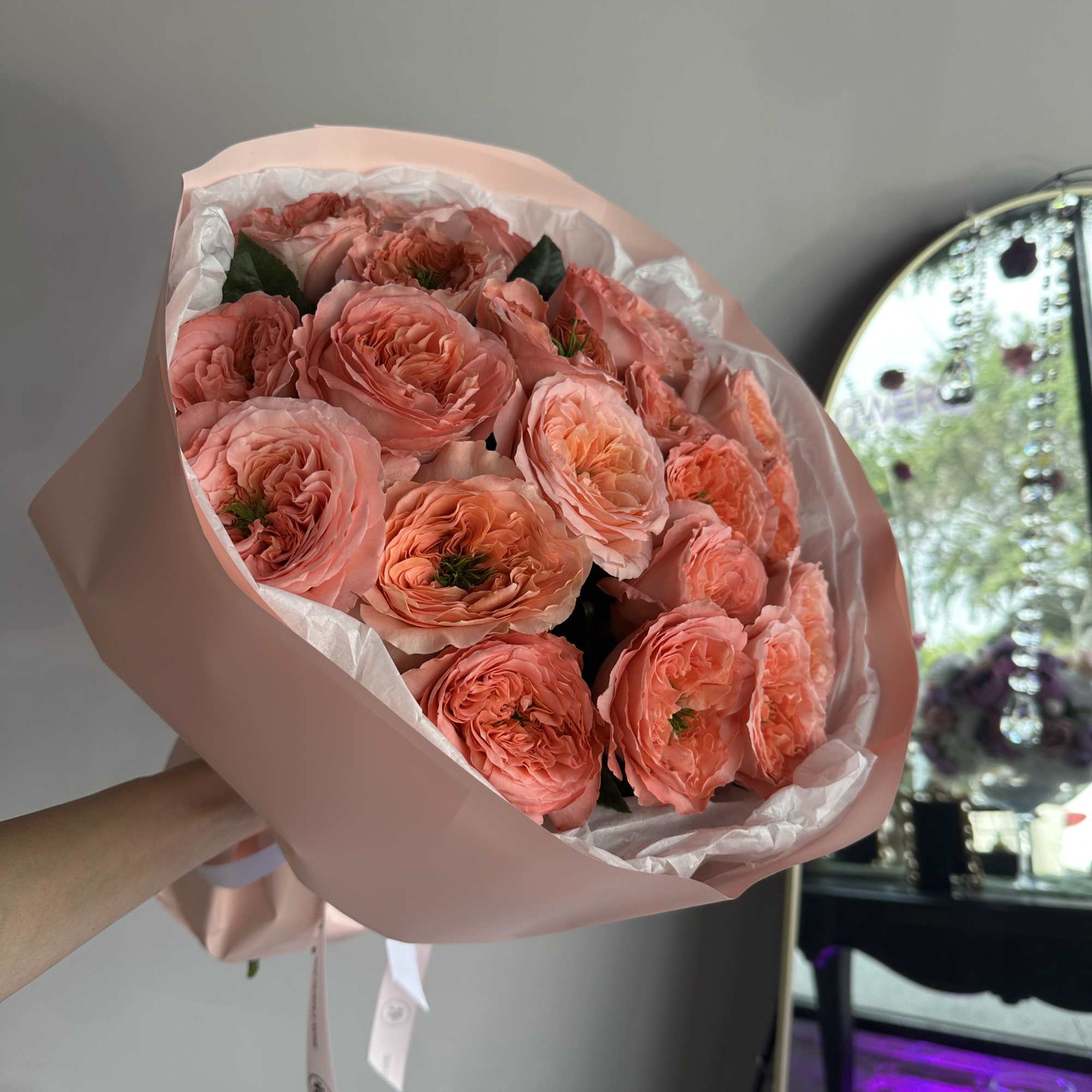 Full of charm and texture, this bouquet of coral-toned garden roses is