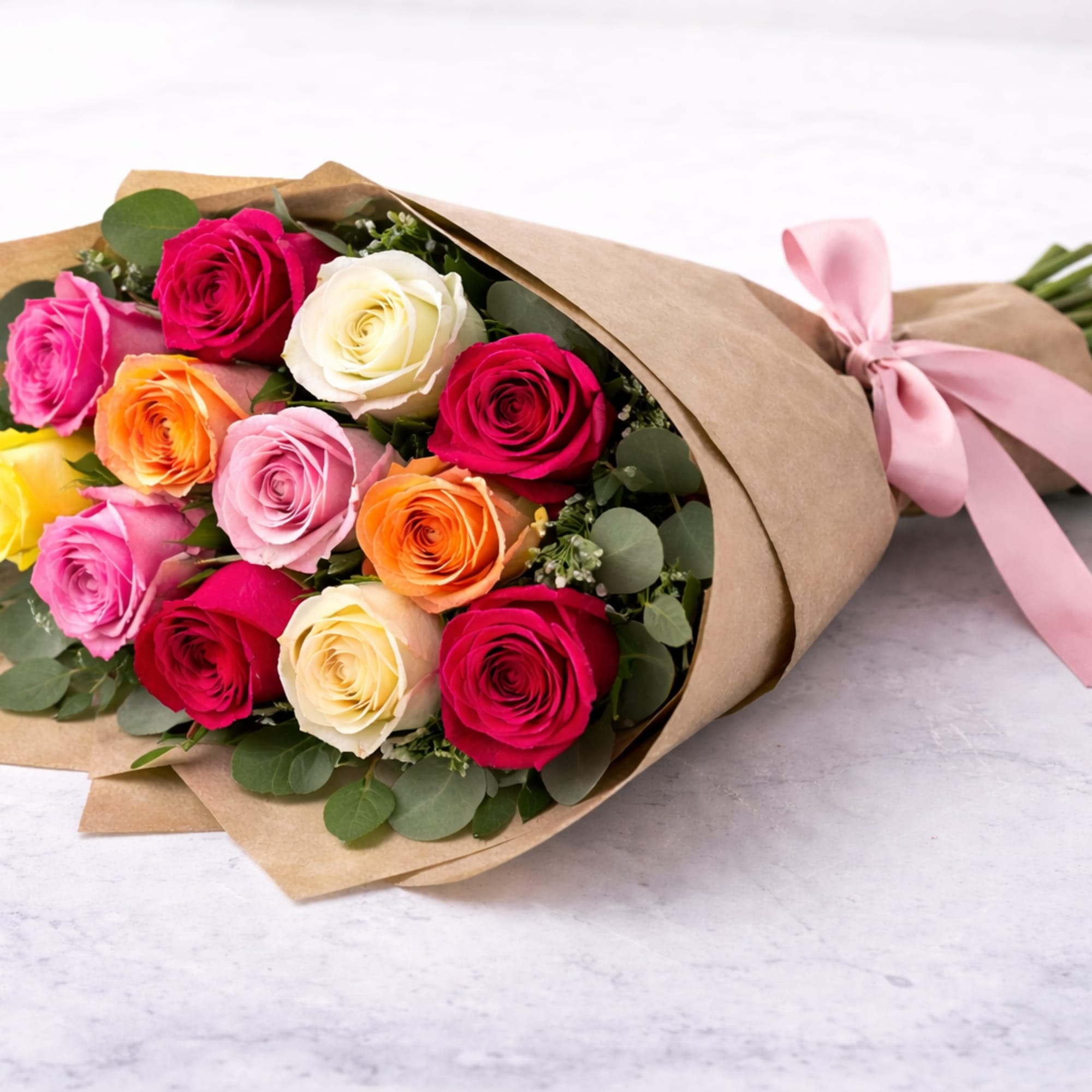 A beautiful wrapped bouquet of premium roses in assorted colors, accented with