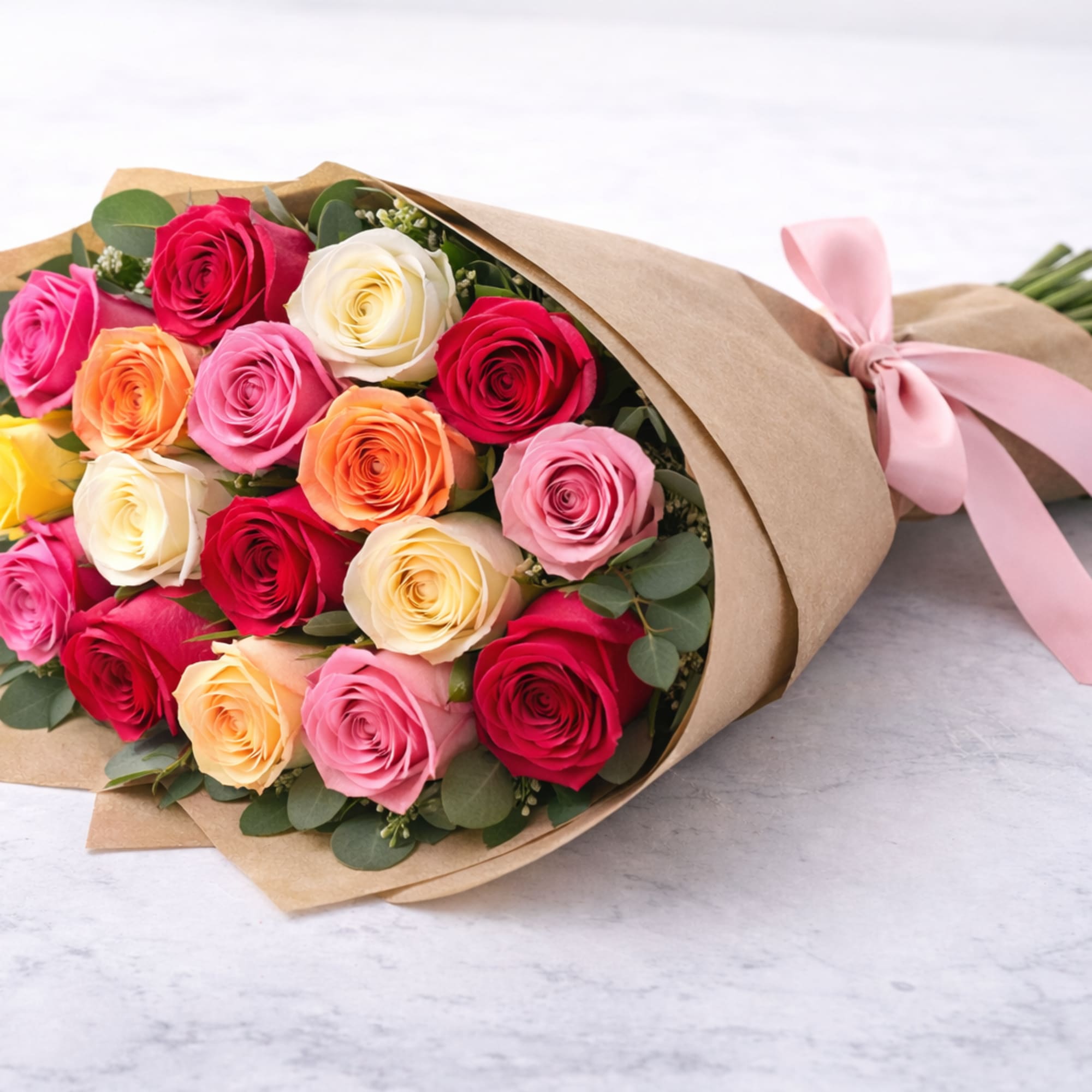 A beautiful wrapped bouquet of premium roses in assorted colors, accented with