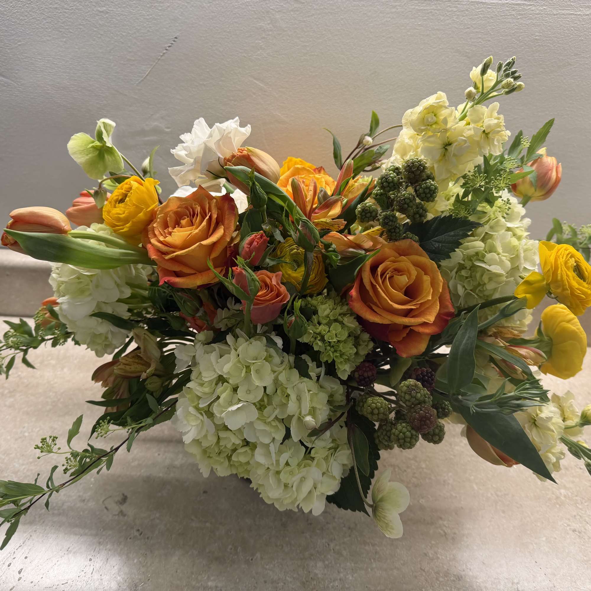 beautiful 
white lisianthus ,
ranunculus,
 tulips spray roses orange,
 Helleborus, 
green hydrangeas
blue Barrys