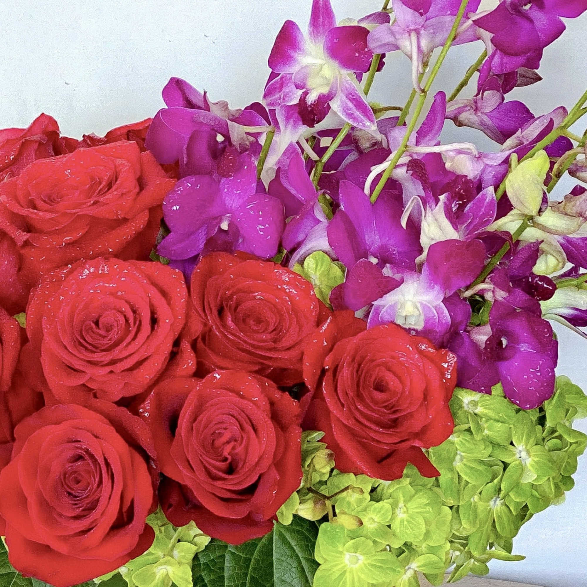 A celebration of luxury and life, this large and jewel toned arrangement