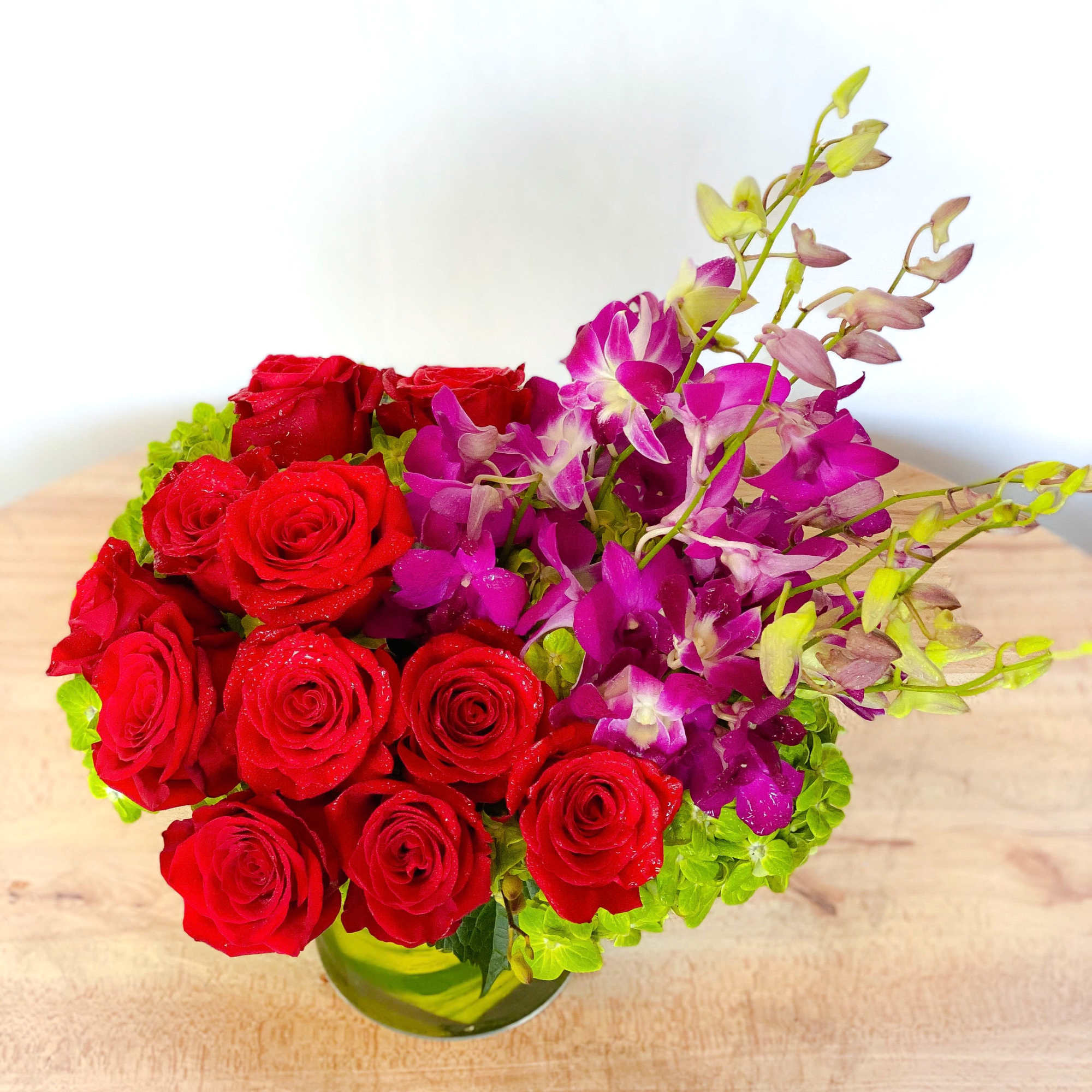 A celebration of luxury and life, this large and jewel toned arrangement