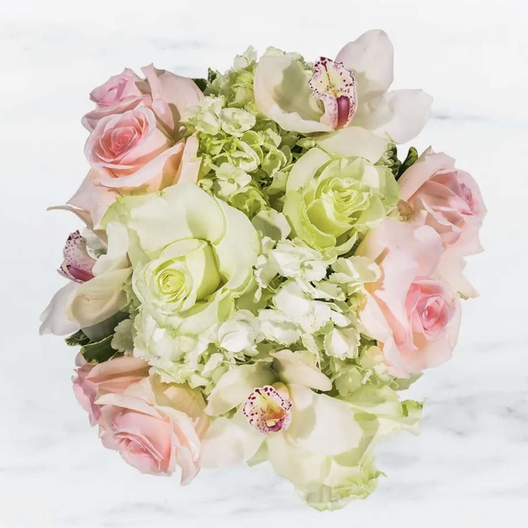 This elegant bouquet of cymbidium orchids, roses and hydrangeas arranged in a