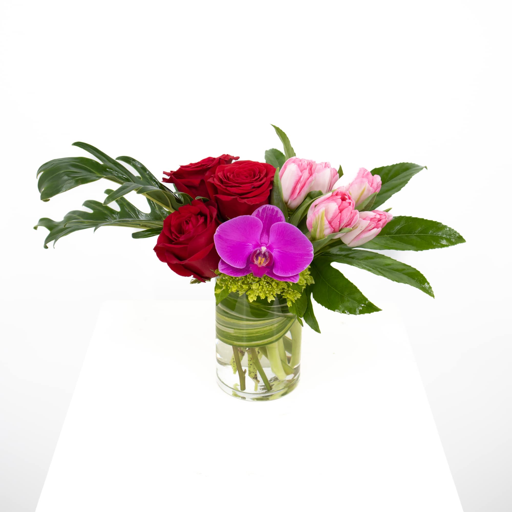 This stunning arrangement that includes gorgeous roses of your color preference along