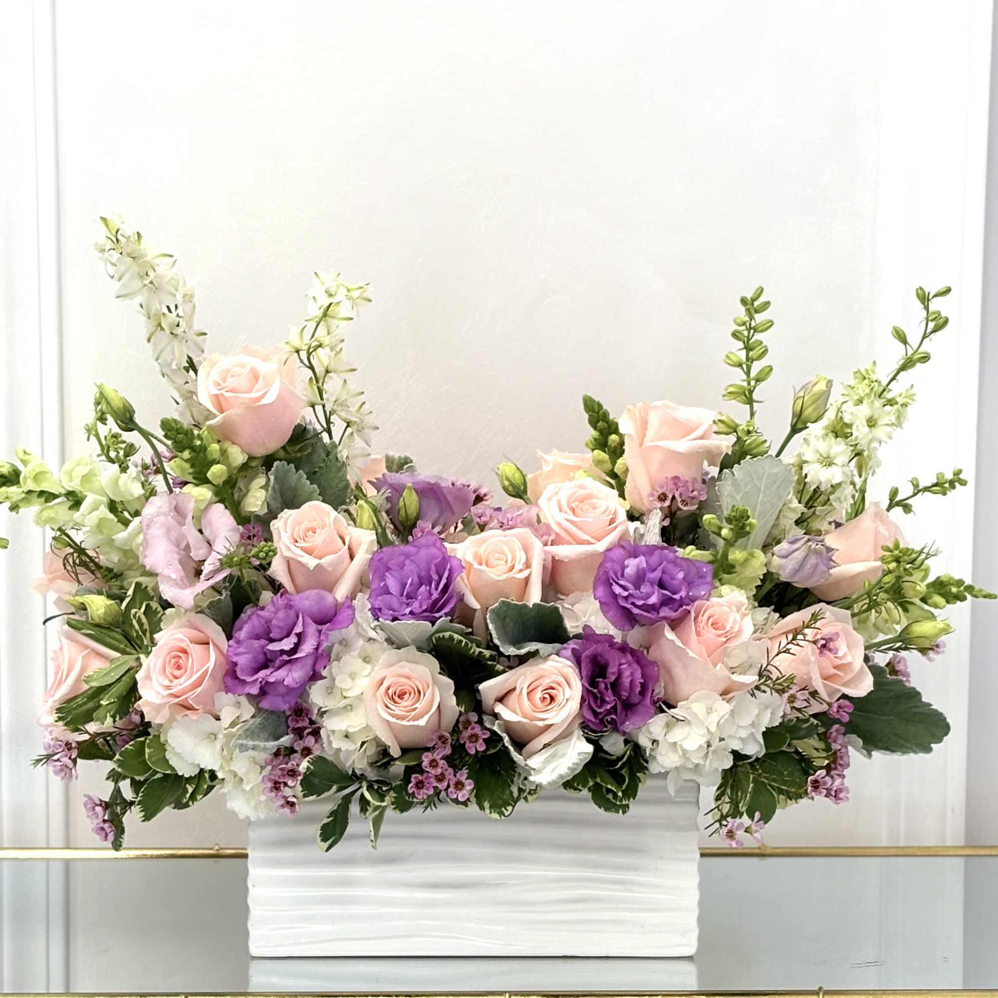 Like a gentle sonata in bloom, this arrangement weaves together pastel florals