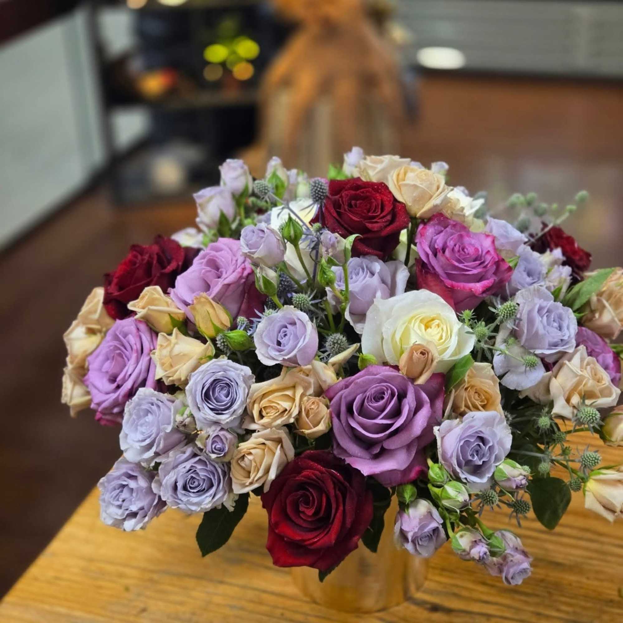 This lovely display of full size and spray roses is stunning and