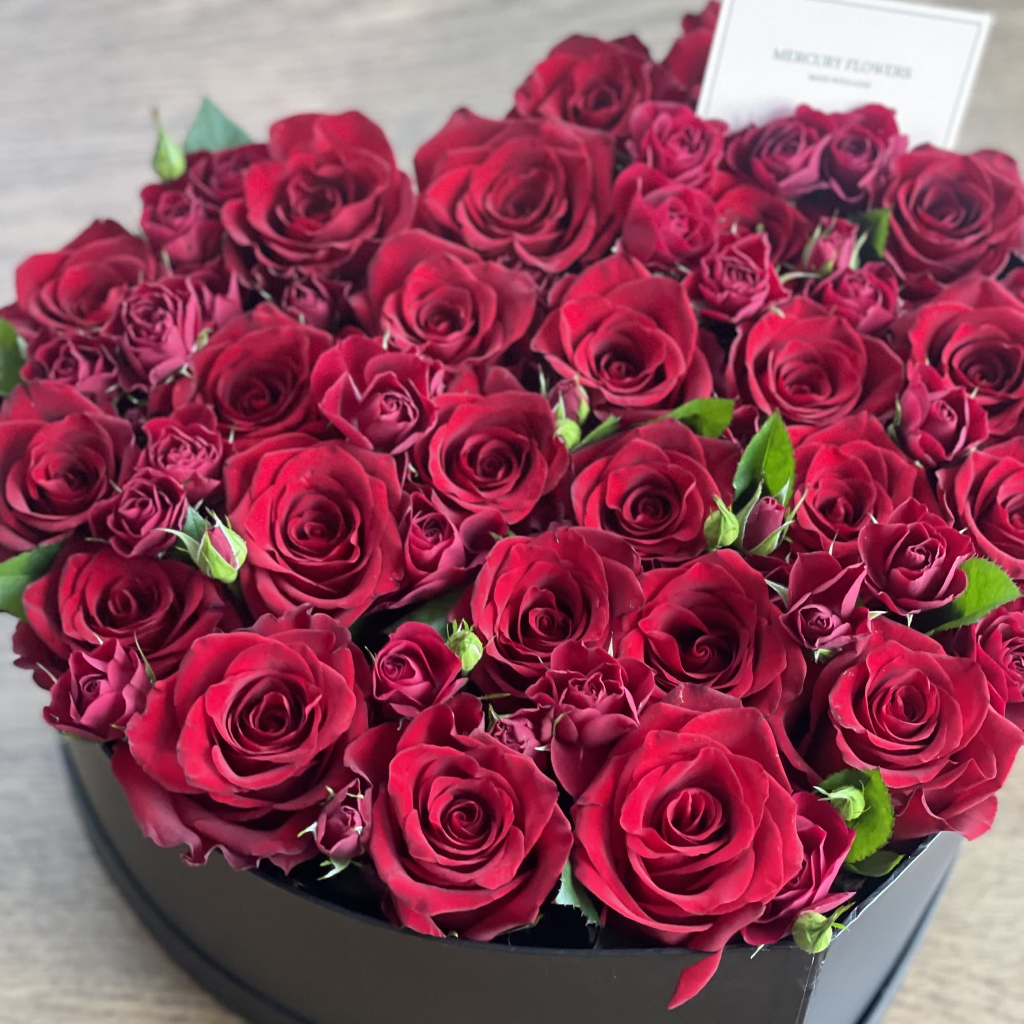 Gorgeous heart box with mix of red roses and garden red roses