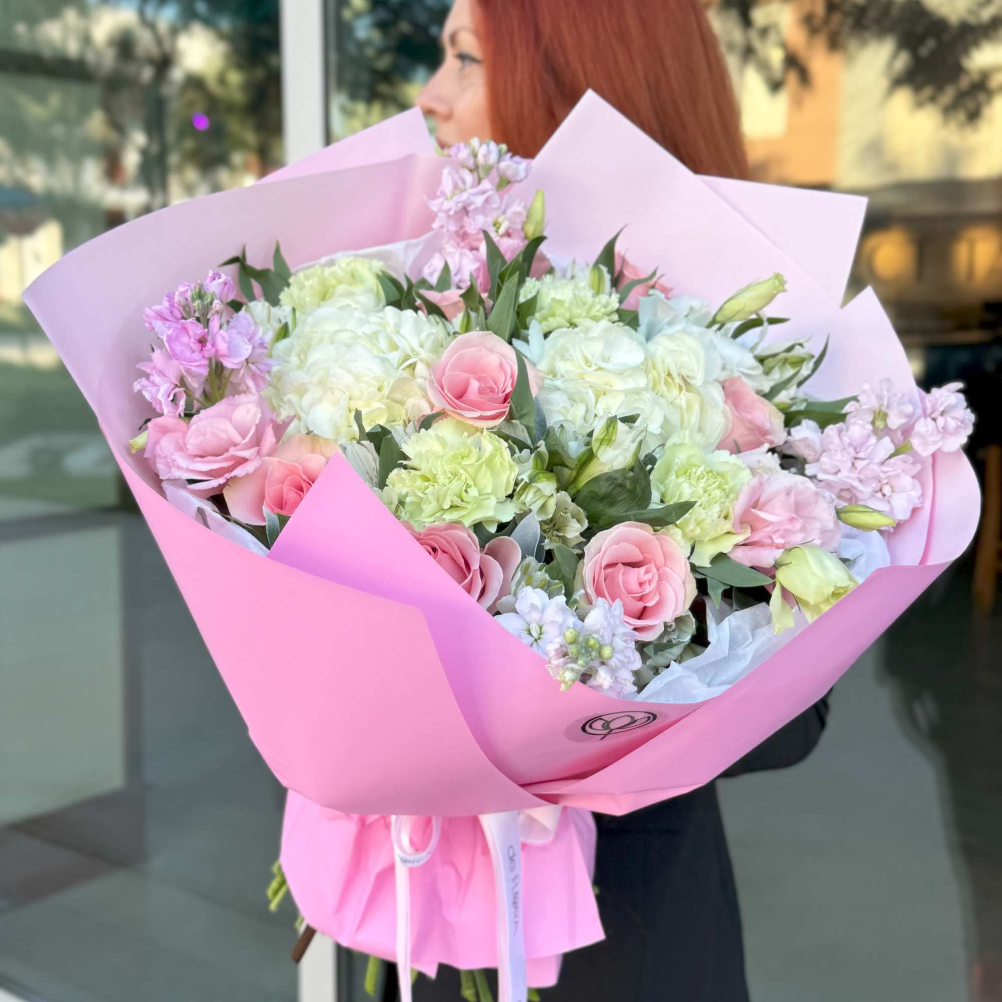 This bouquet has a soft, romantic feel with pastel pinks, whites, and