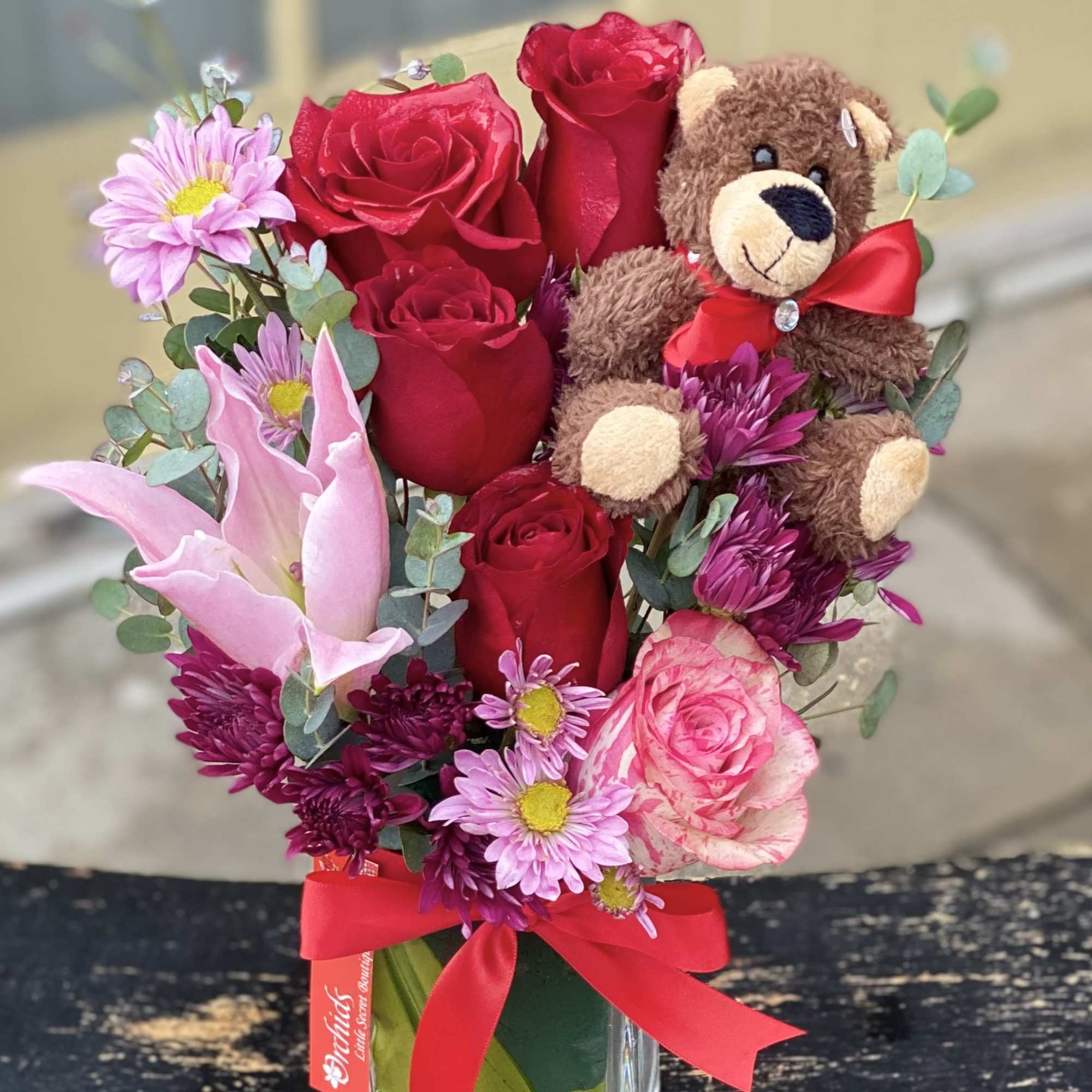 Arrangement Measures approximately 13"H 
Make your recipient smile today with our red